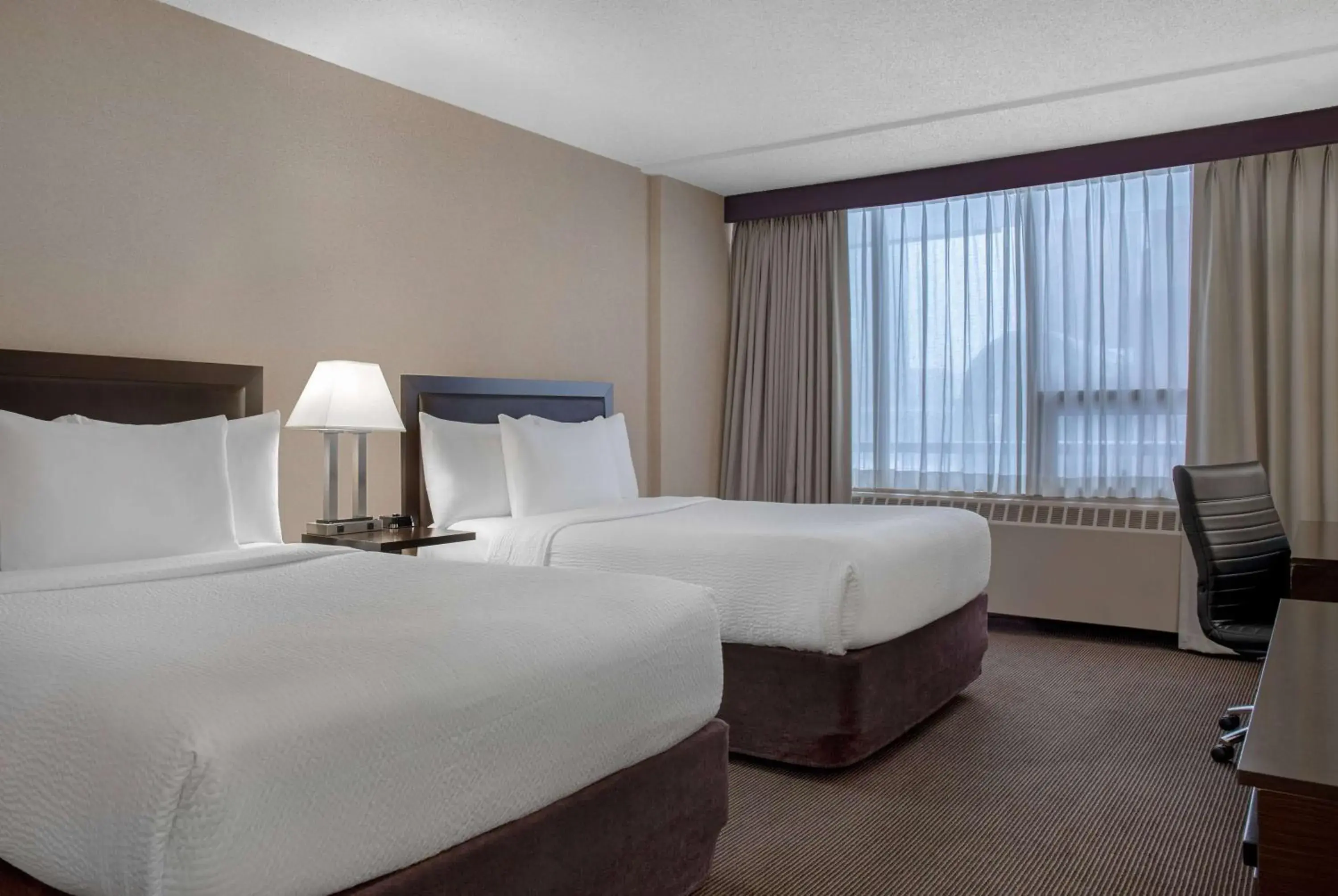 Photo of the whole room, Bed in Ramada Plaza by Wyndham Calgary Downtown Photo of the whole room, Bed in Ramada Plaza by Wyndham Calgary Downtown