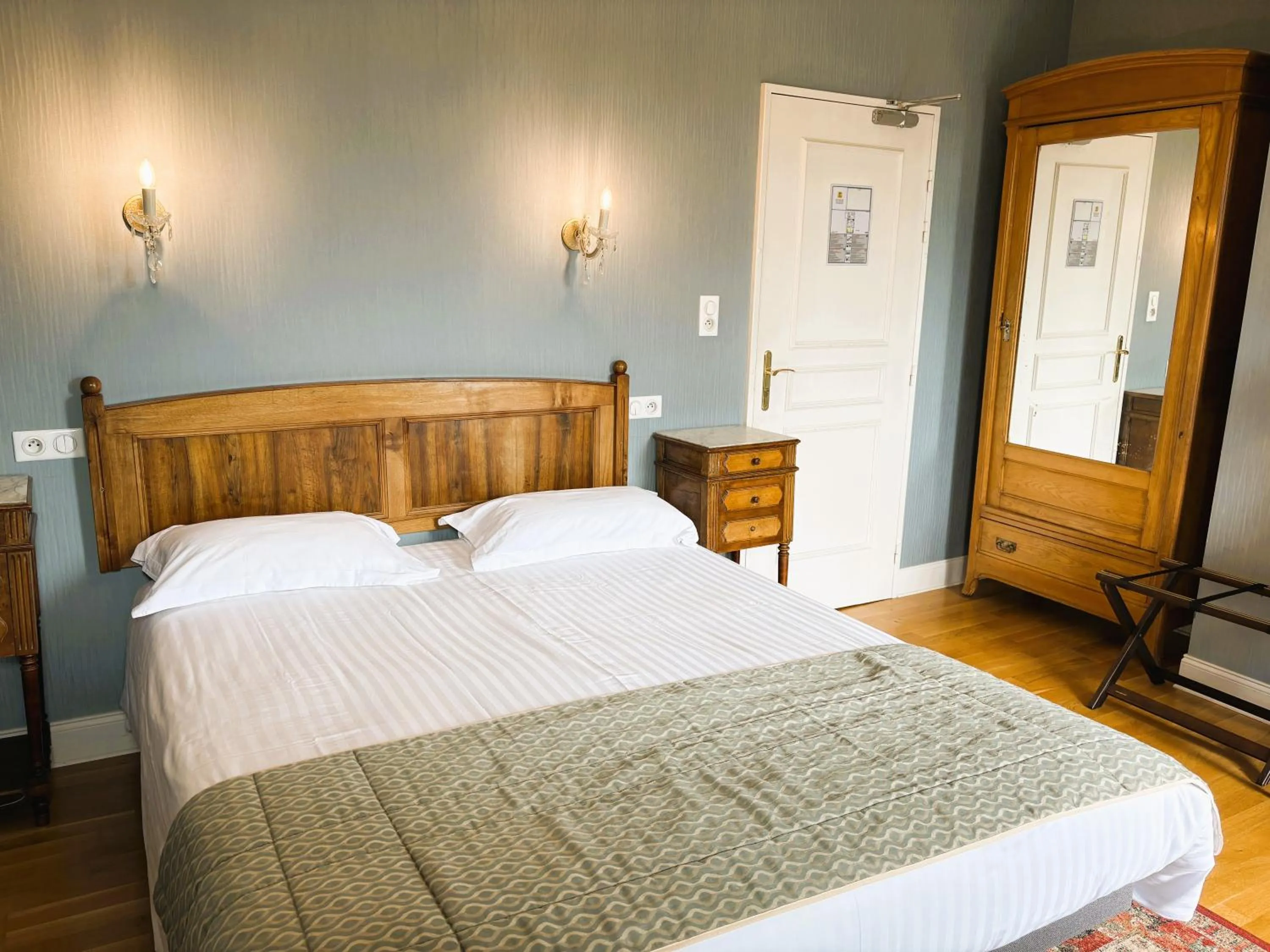 Bed in Logis Hôtel Beau Site