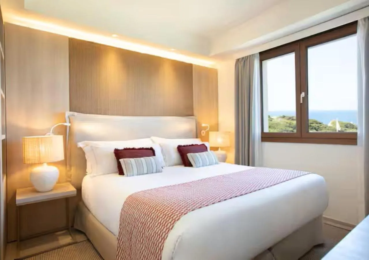 Bed in Mangia's Santa Teresa Sardinia, Curio Collection by Hilton