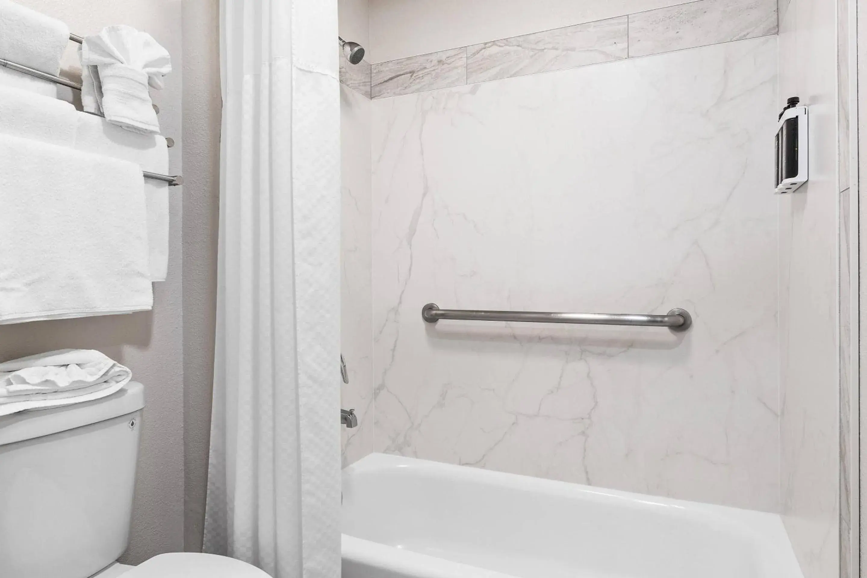 Bedroom in University Park Inn & Suites, an Ascend Collection Hotel Bedroom in University Park Inn & Suites, an Ascend Collection Hotel