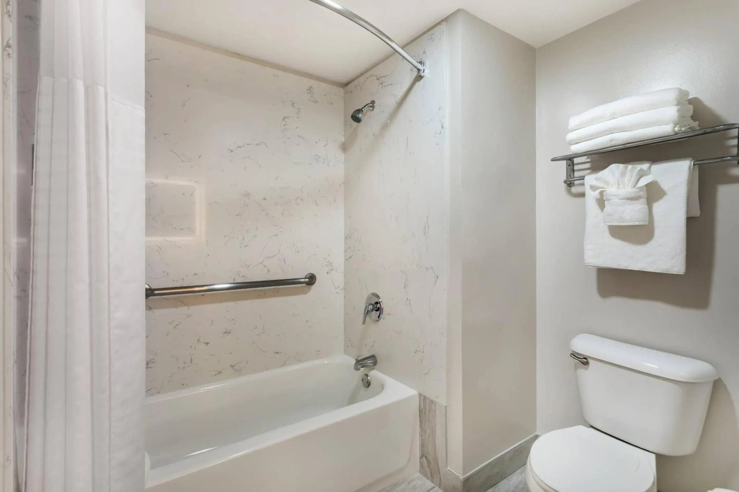 Bedroom in University Park Inn & Suites, an Ascend Collection Hotel Bedroom in University Park Inn & Suites, an Ascend Collection Hotel