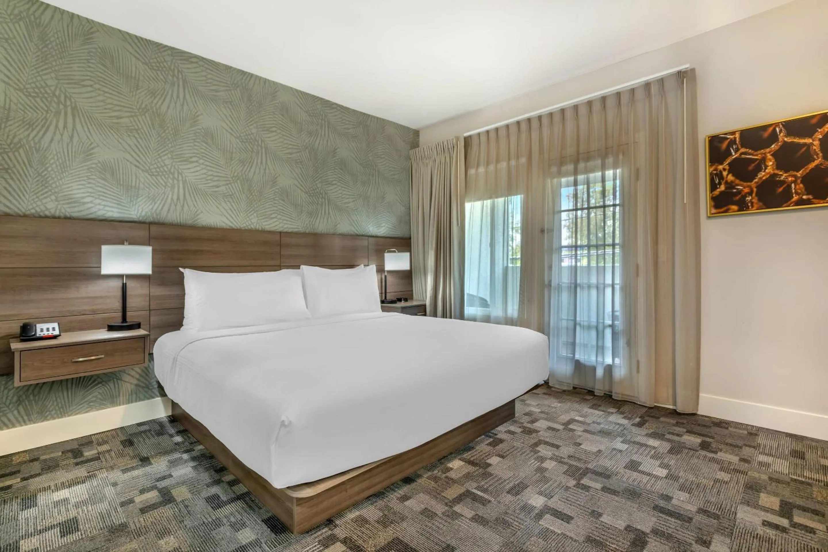 Bedroom, Bed in University Park Inn & Suites, an Ascend Collection Hotel