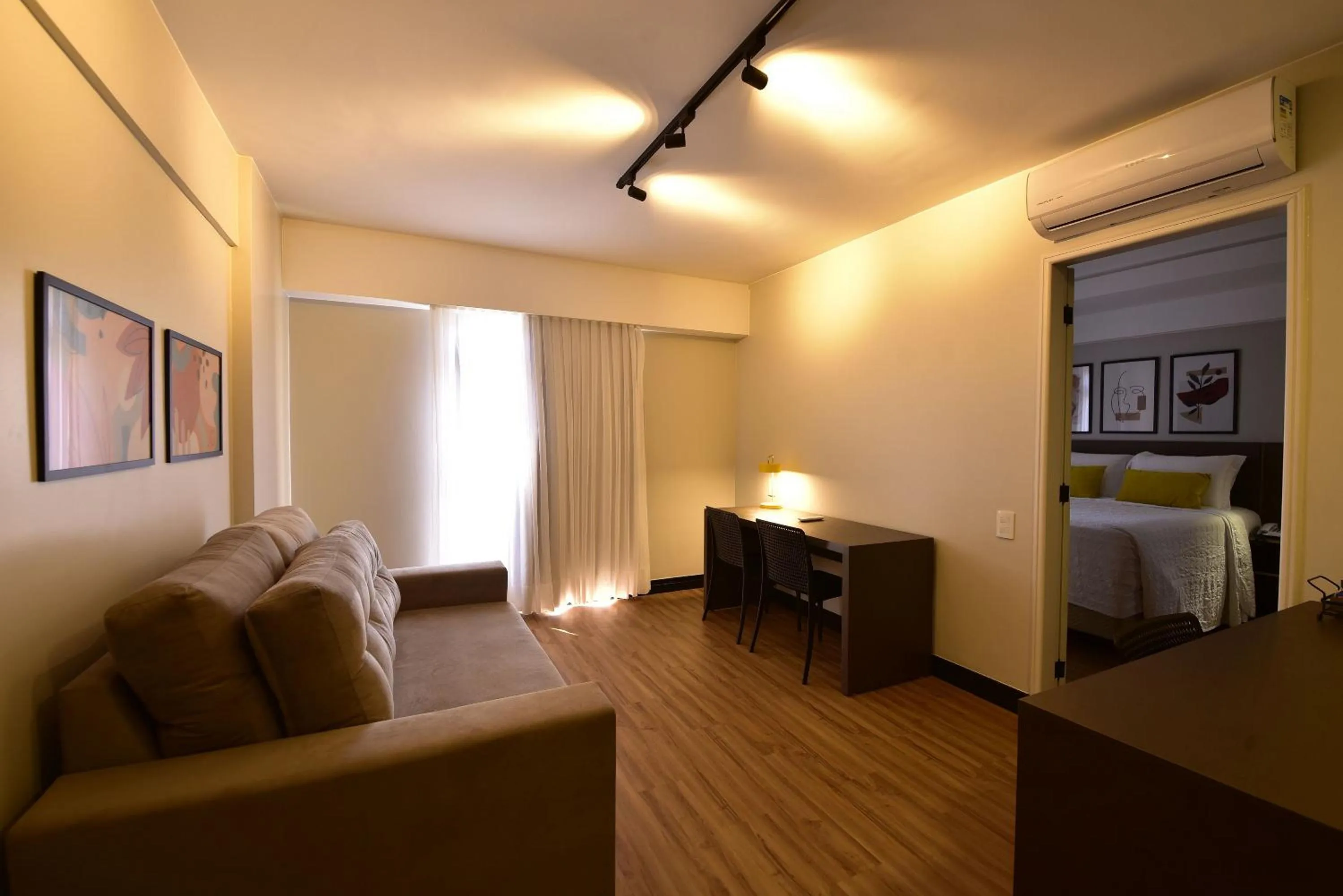 Seating area, Bed in Golden Tulip Goiania Address