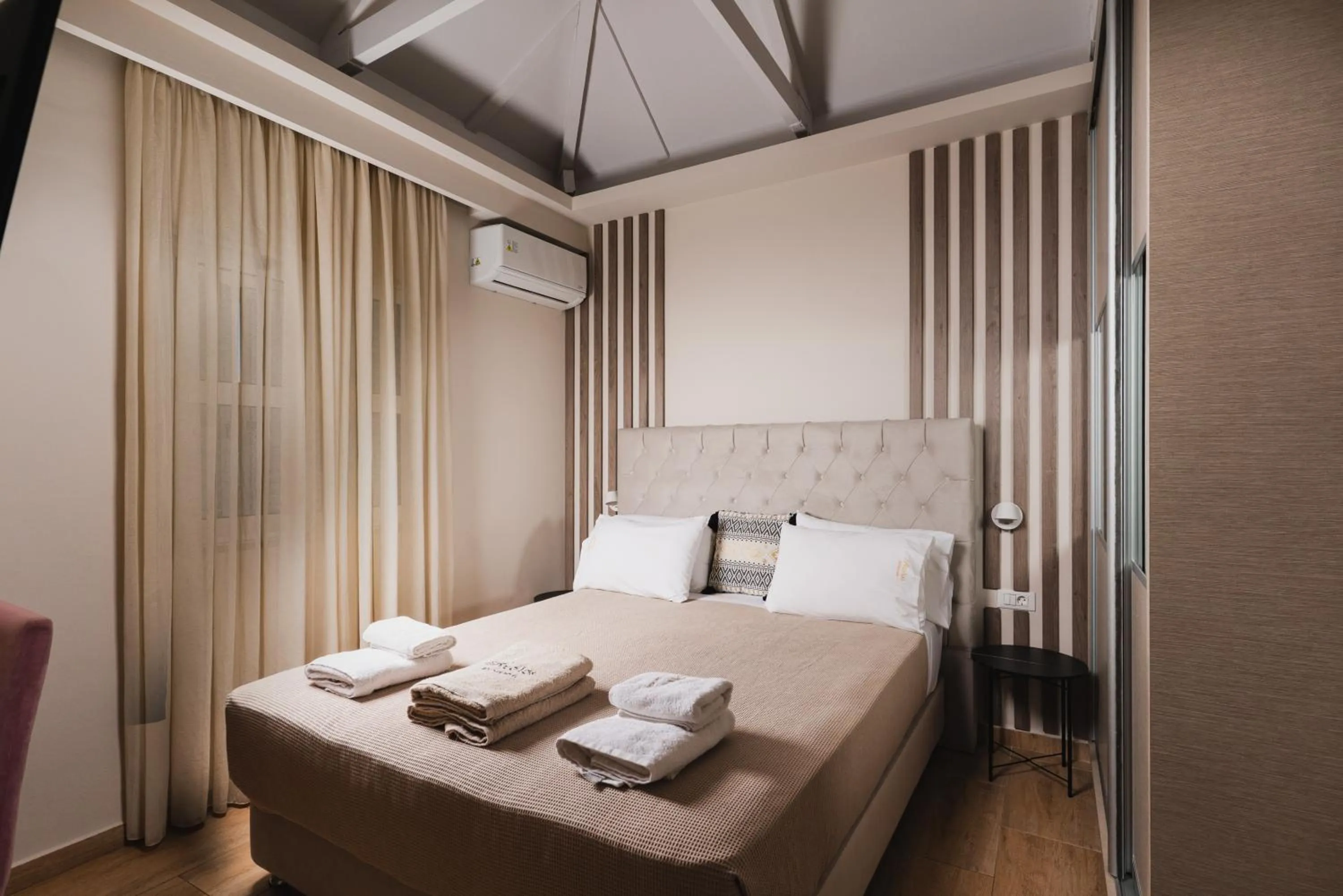 Bed in Aeolos Boutique Hotel & Suites