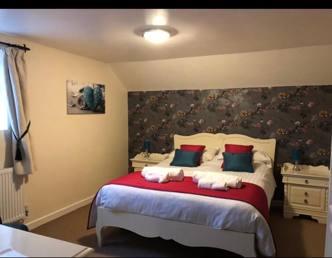 Bed in The Jug & Glass Inn