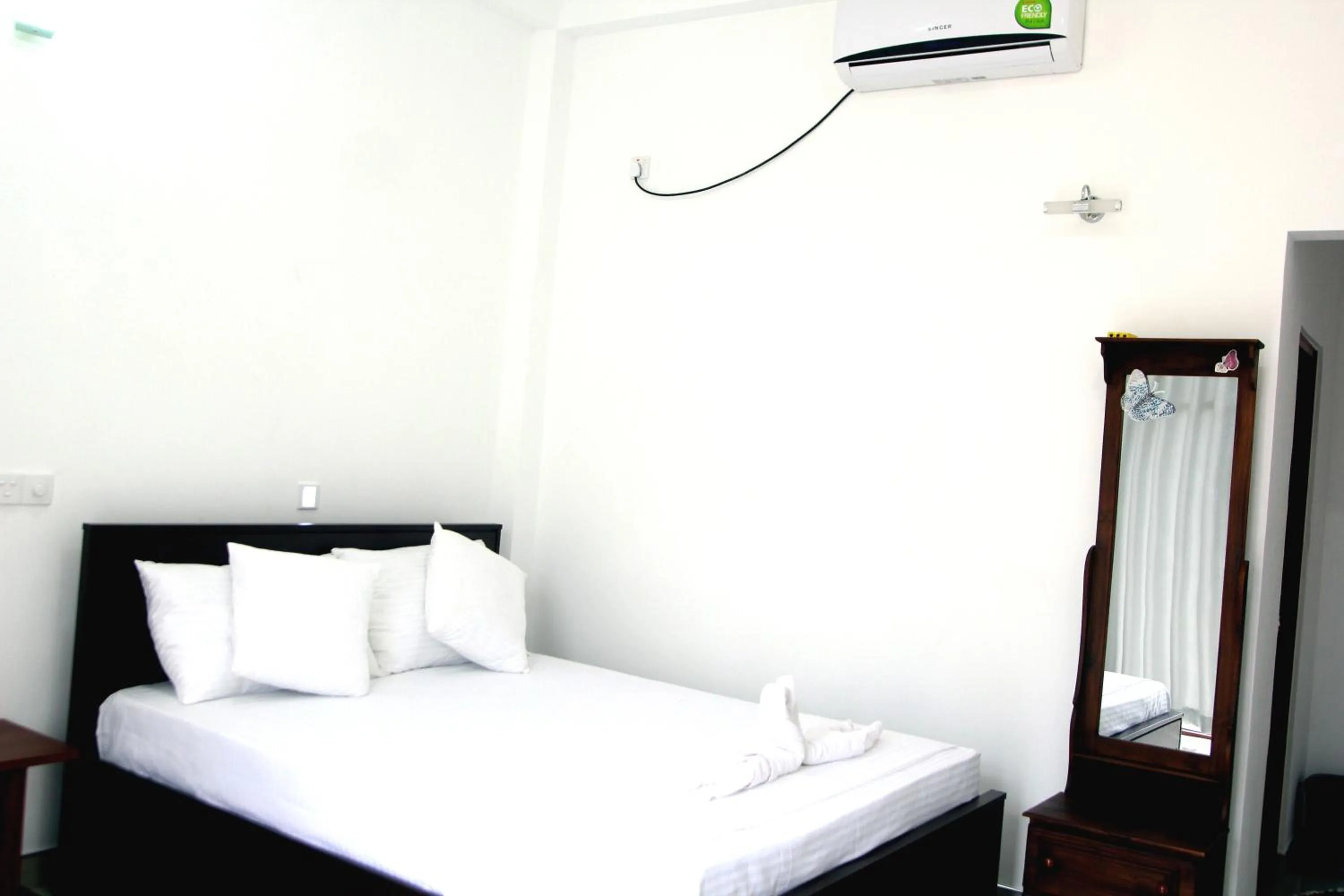 Bed in Butterfly Homestead Hotel