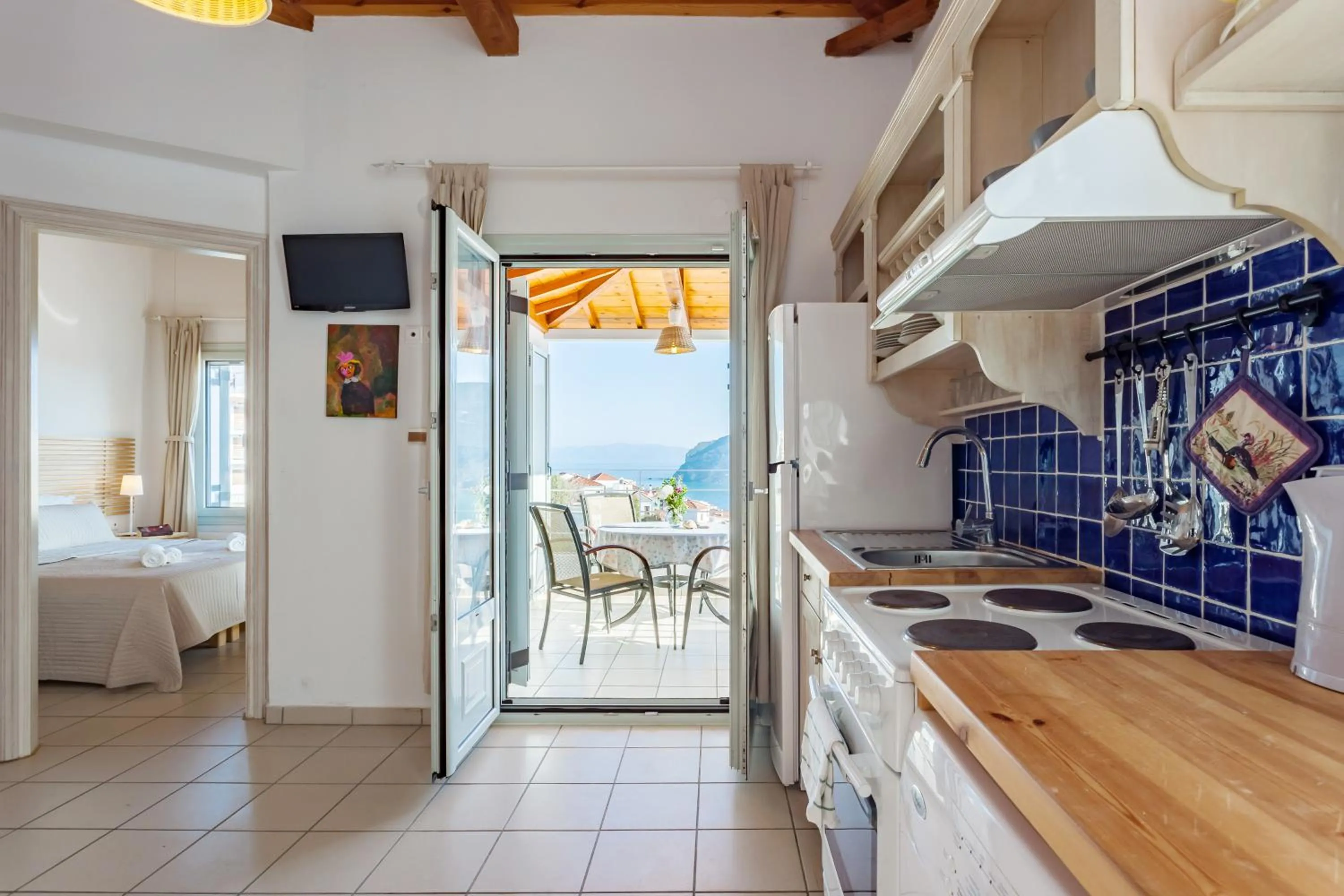 Kitchen or kitchenette, Bed in Thea Home Hotel by Booking Kottas