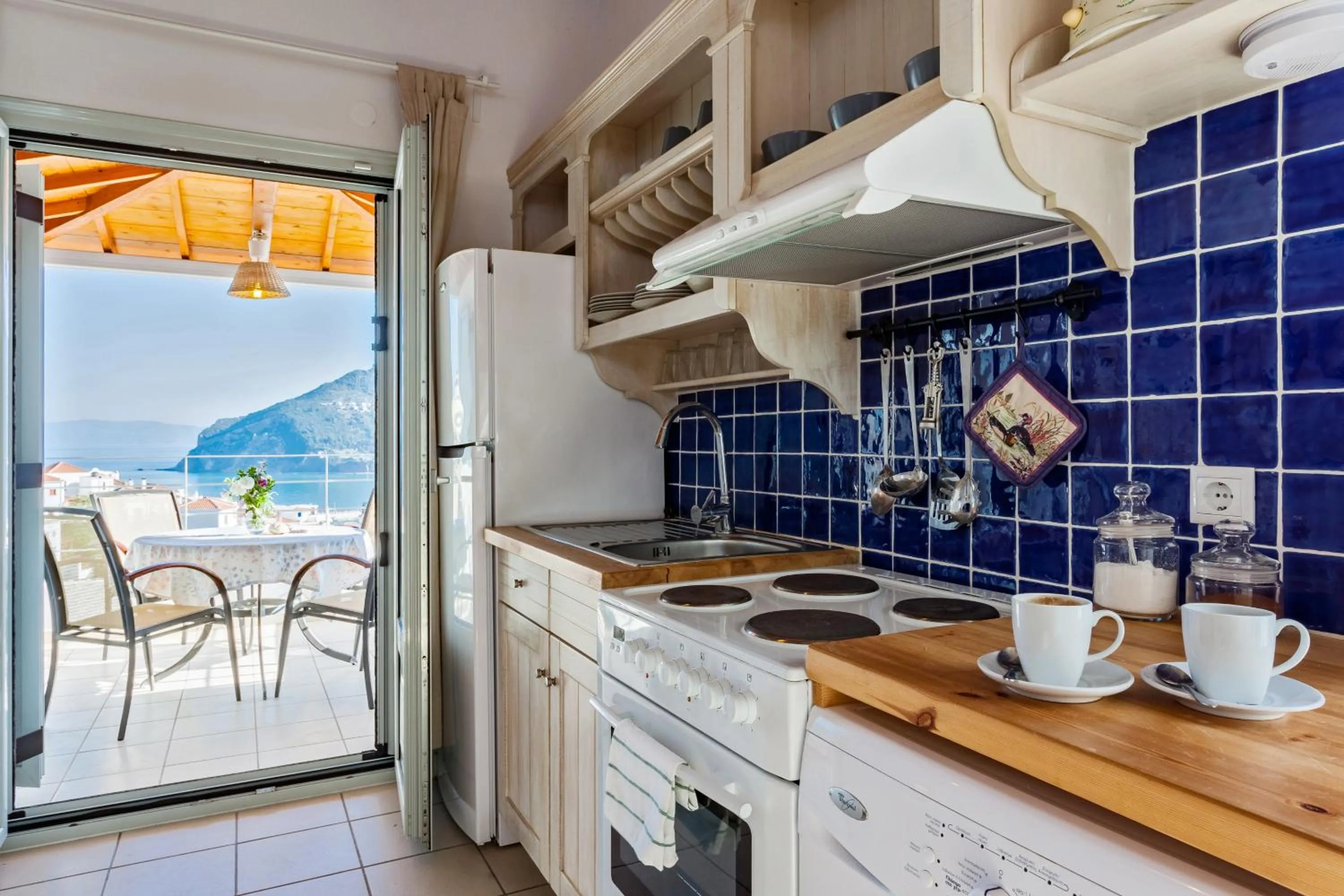 Kitchen or kitchenette in Thea Home Hotel by Booking Kottas