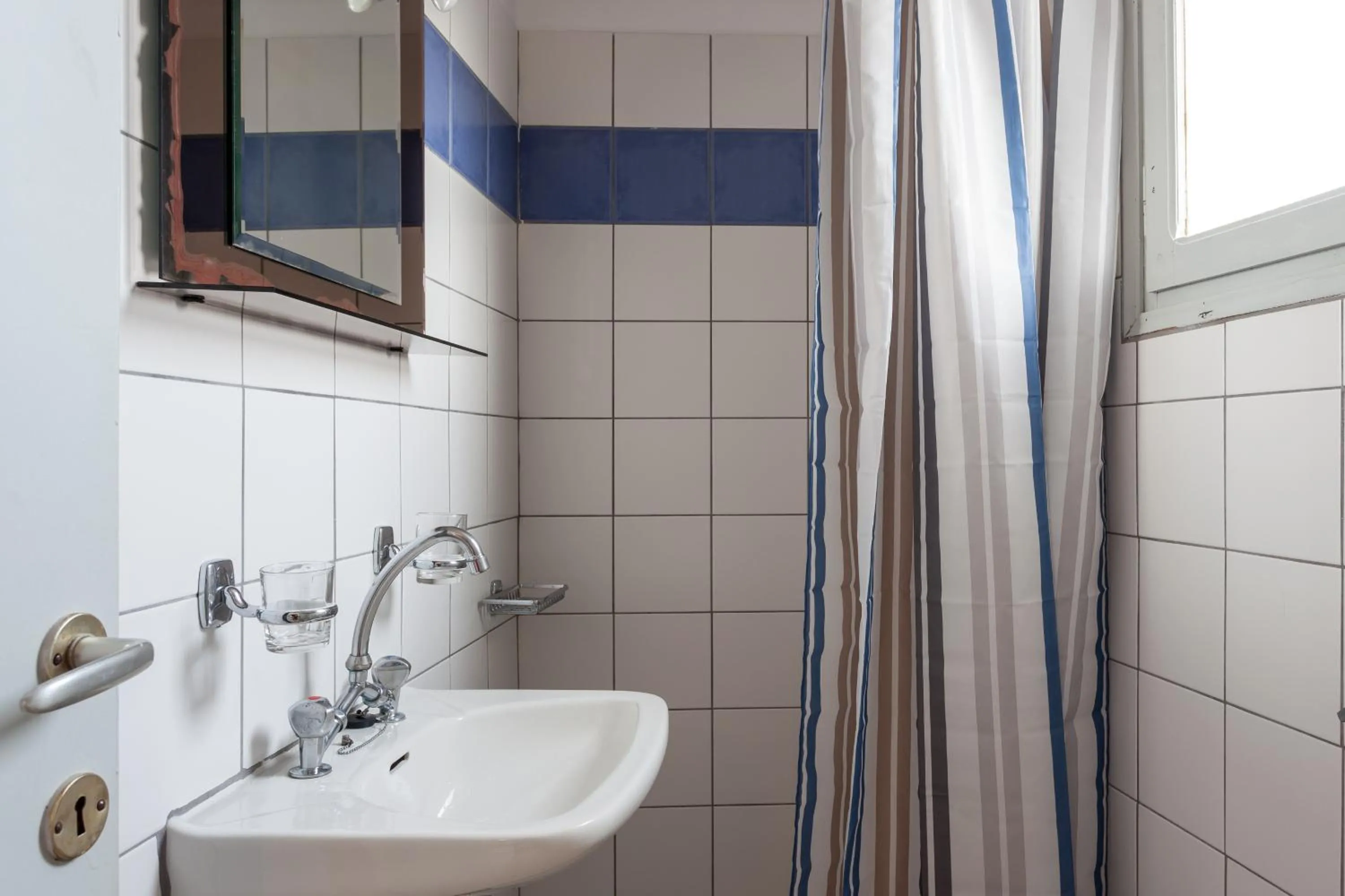 Toilet in Thea Home Hotel by Booking Kottas