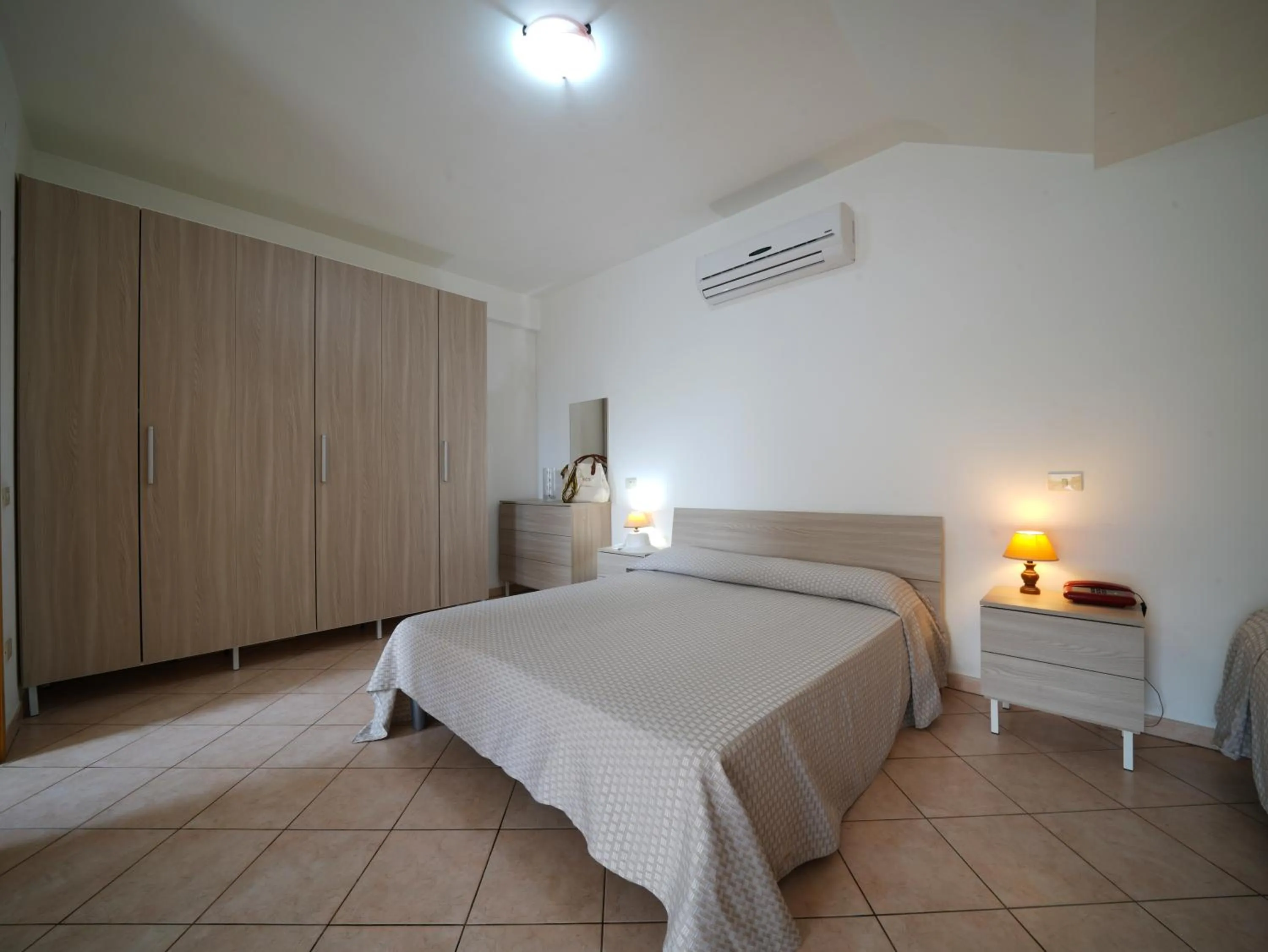 Bed in Rosy Hotel Residence