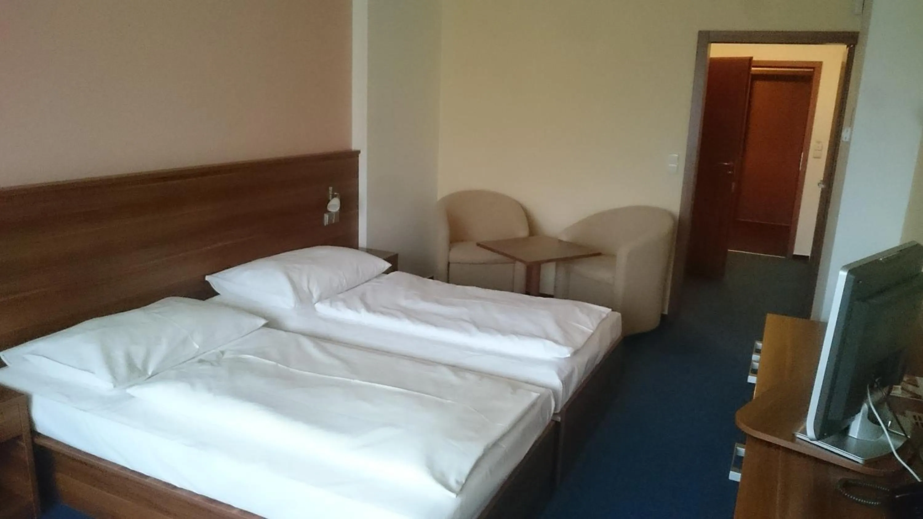 Bed in LIPNO WELLNESS - FRYMBURK HOTEL private family room