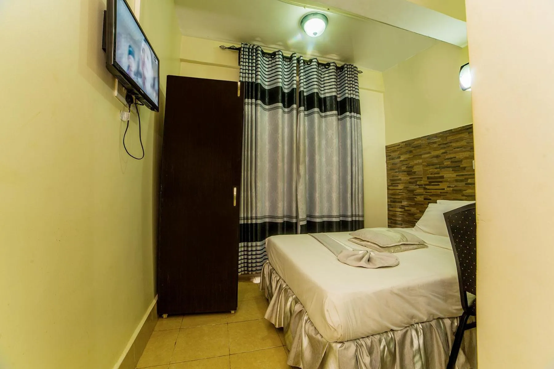 Bed in Latitude 1 Suites