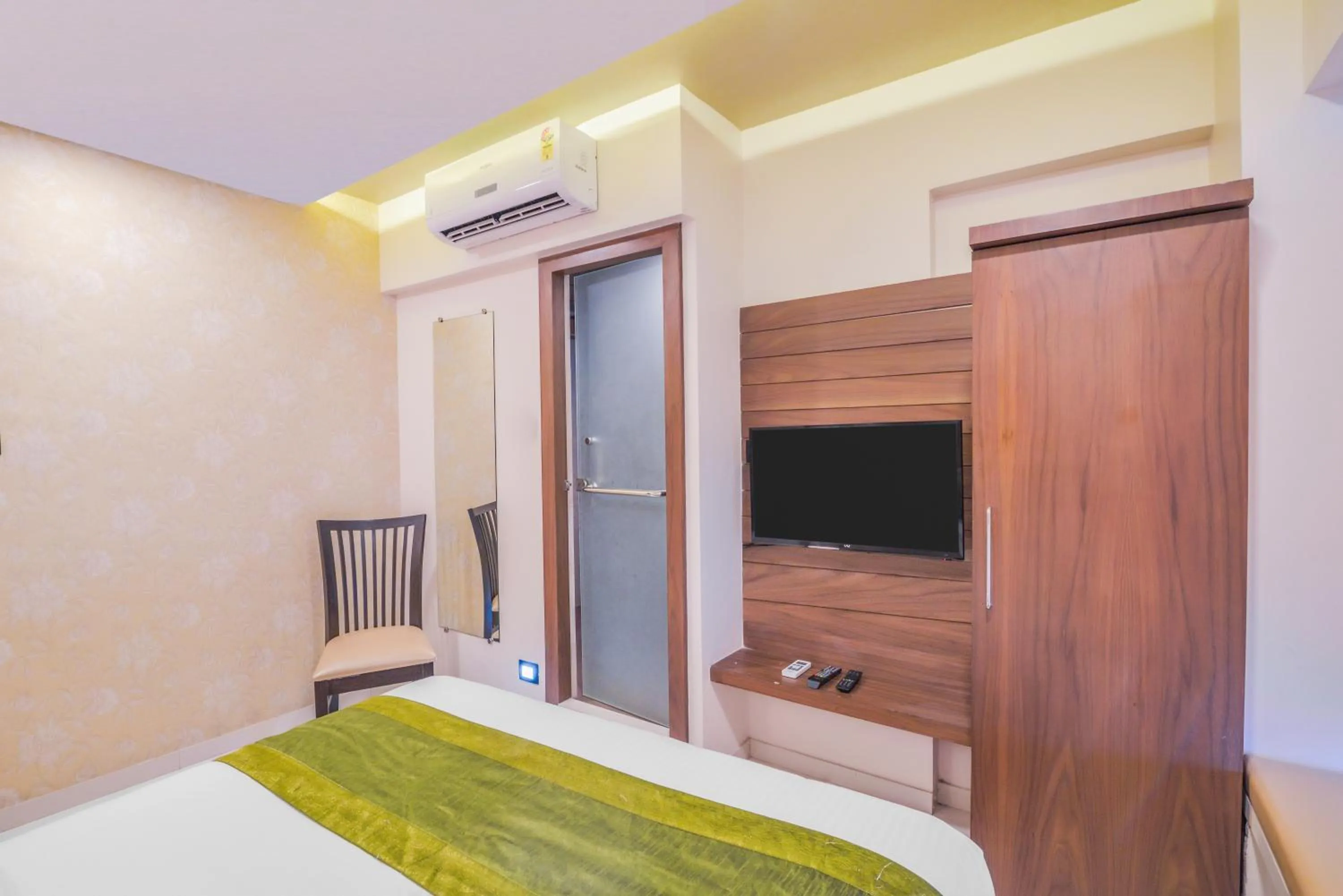 Communal lounge/ TV room, Bed in Oxford Hotel Powai