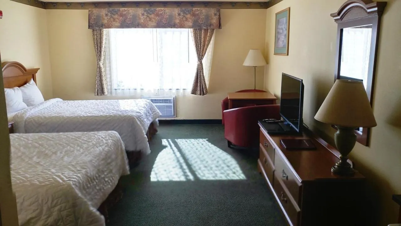 Bed in Palace Inn & Suites