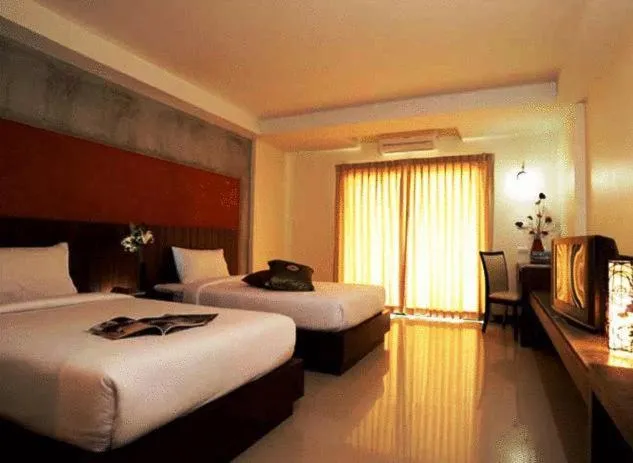 Bed in The Charm Boutique Resort