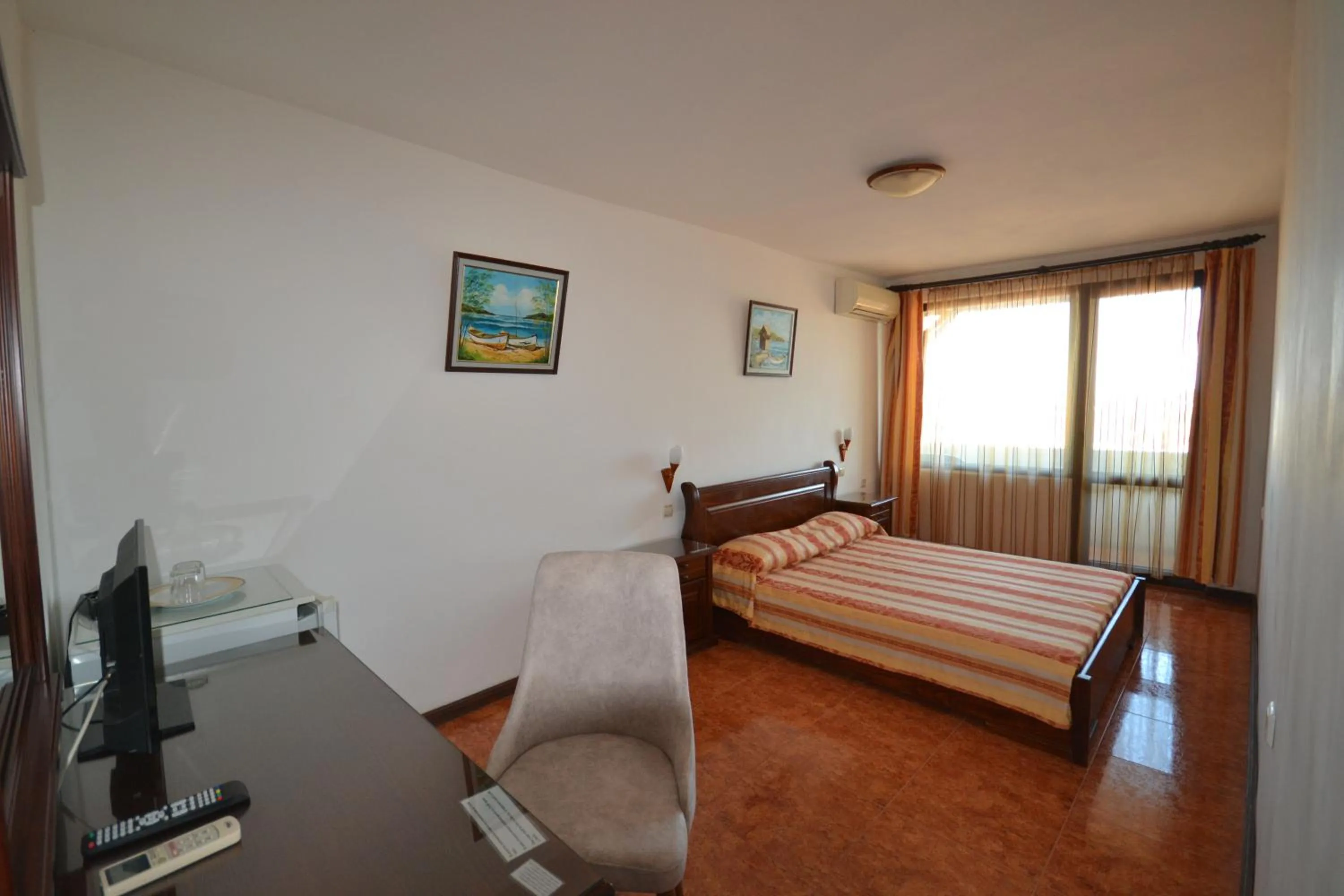 Communal lounge/ TV room, Bed in More Family Hotel