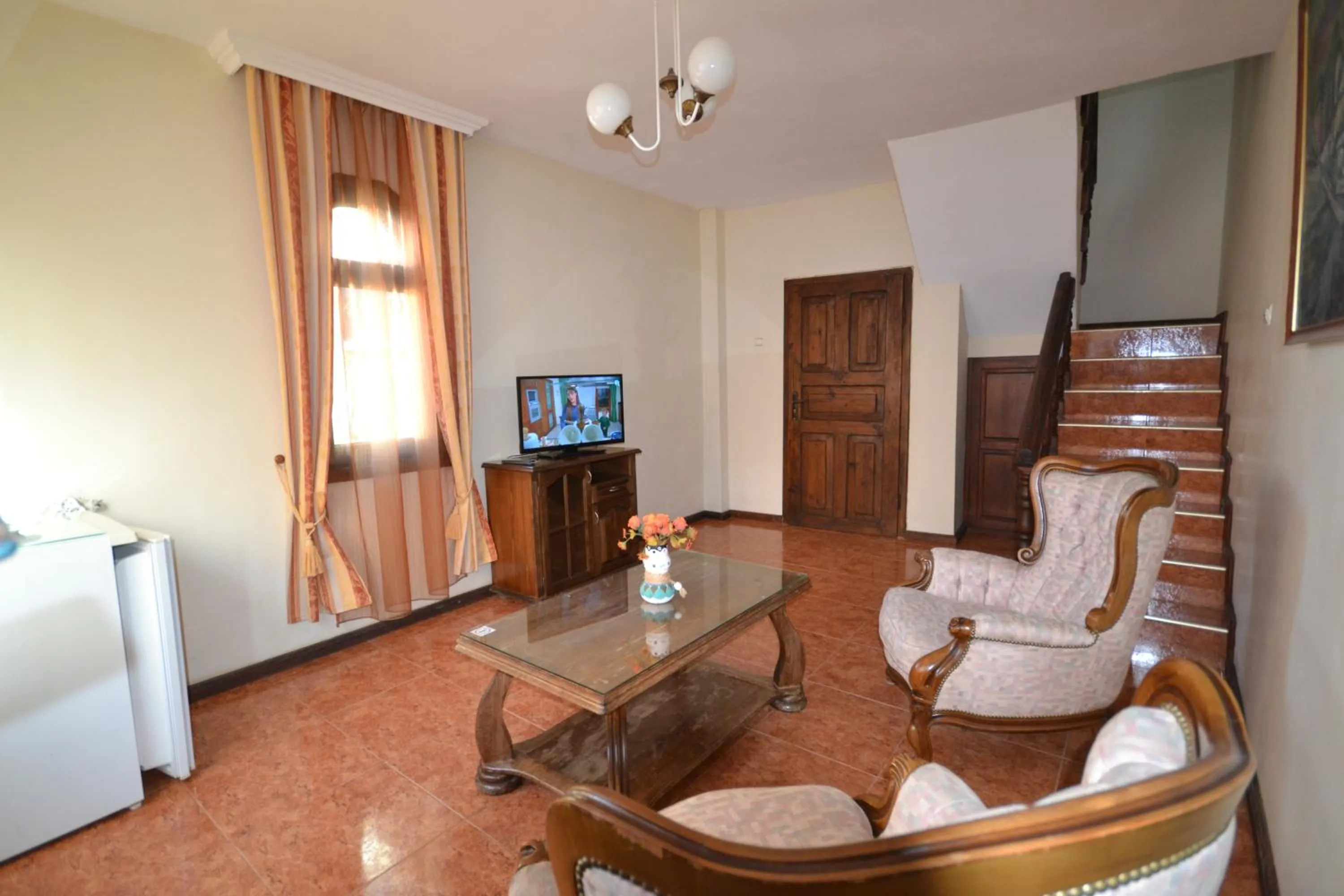 Communal lounge/ TV room in More Family Hotel