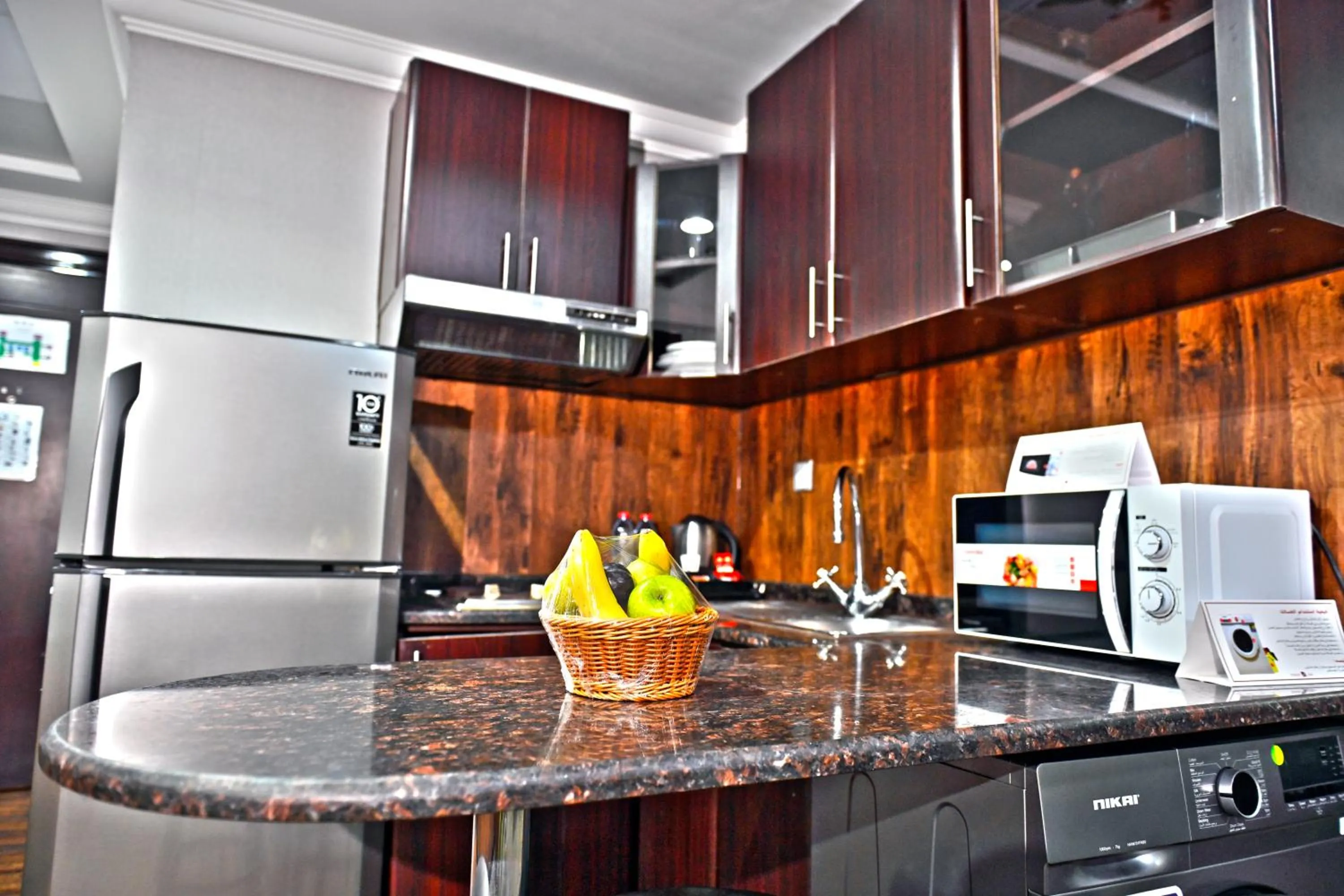 Kitchen or kitchenette in Ewan Ajman Suites Hotel