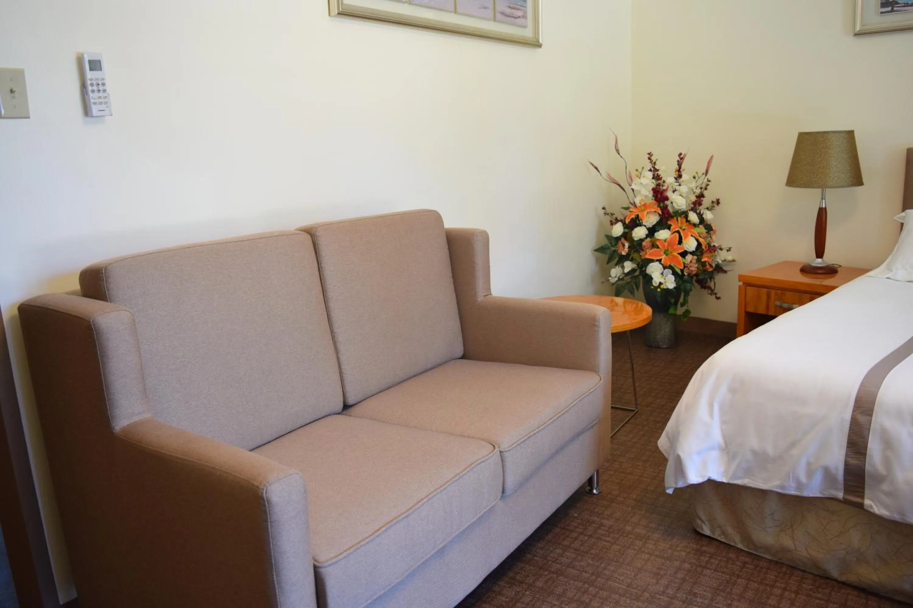 Living room, Bed in Saipan Beach Hotel