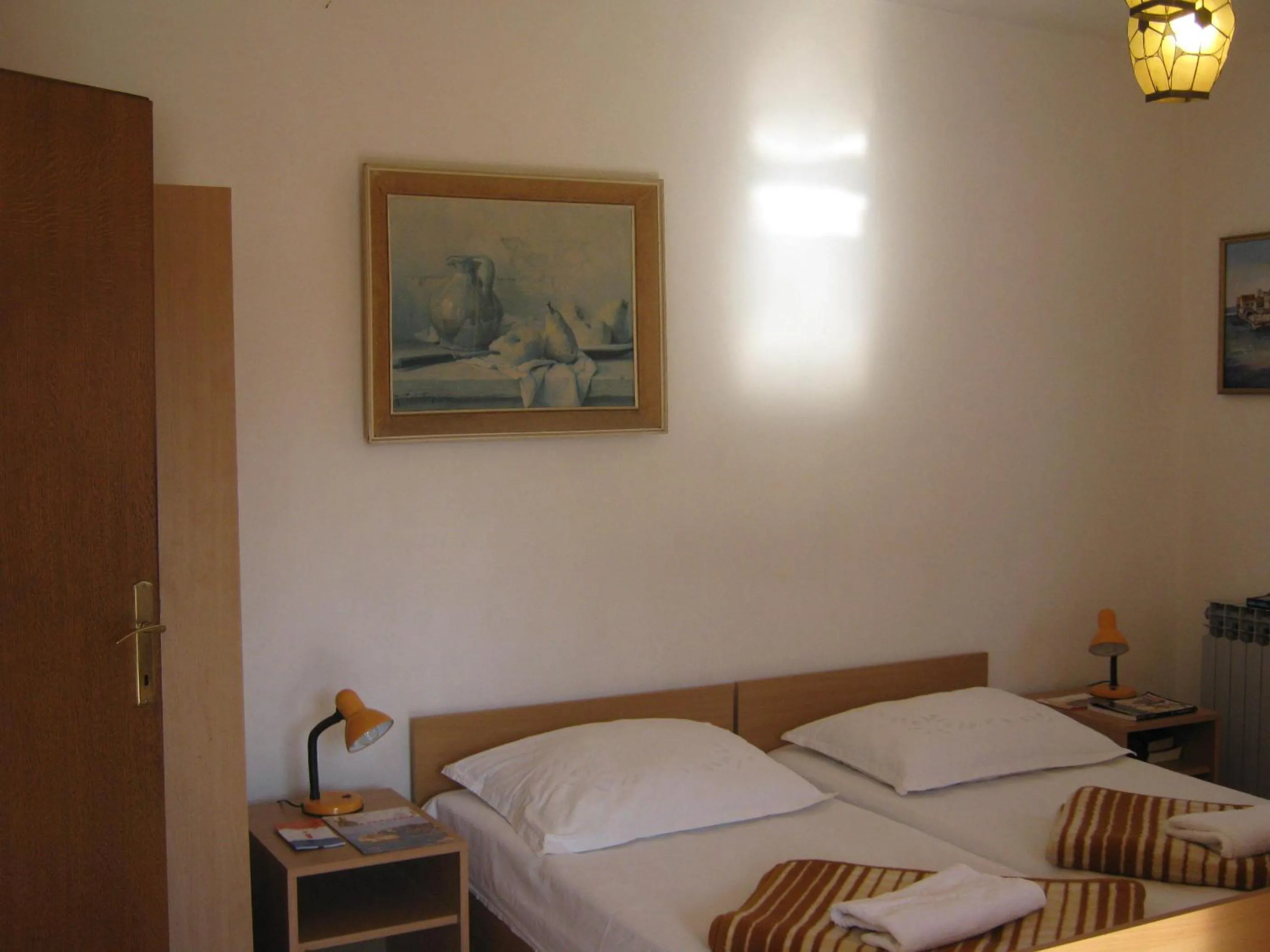 Bed in Apartments and Rooms Artemida