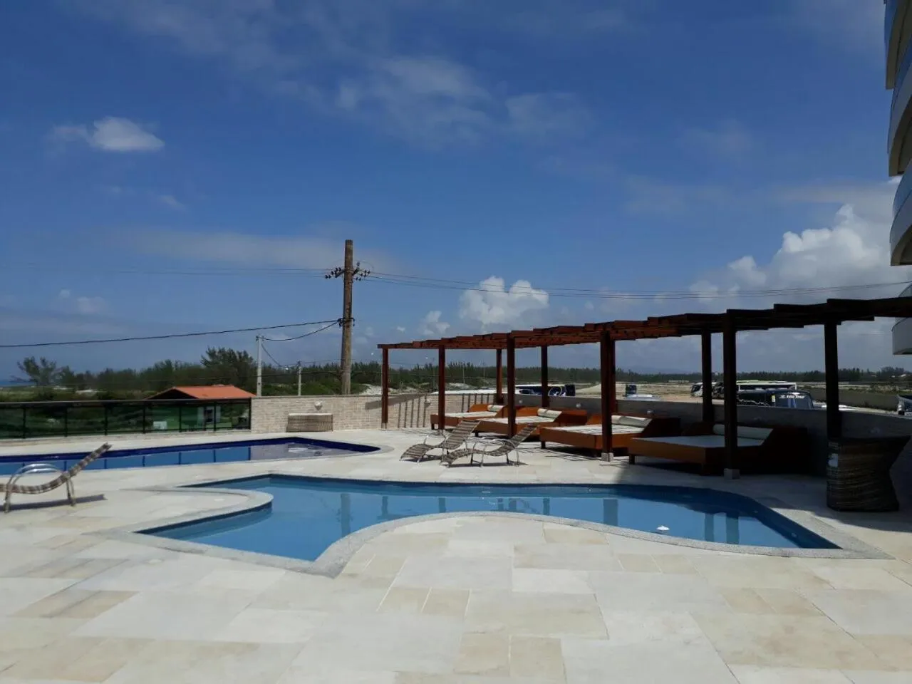 Swimming pool in Apartamento Super Luxo em Arraial do Cabo