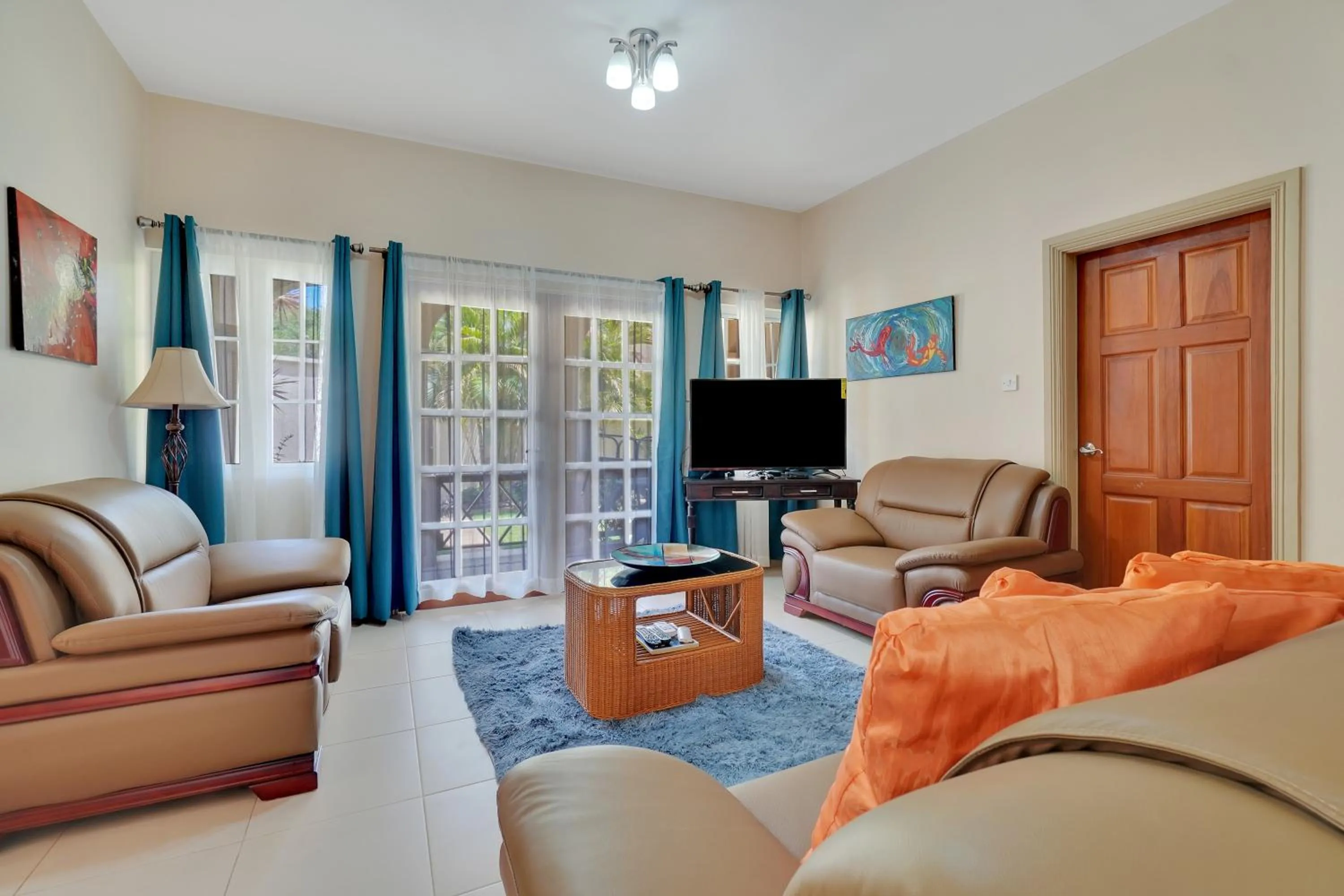 Communal lounge/ TV room in Mandela Court Suites Grenada