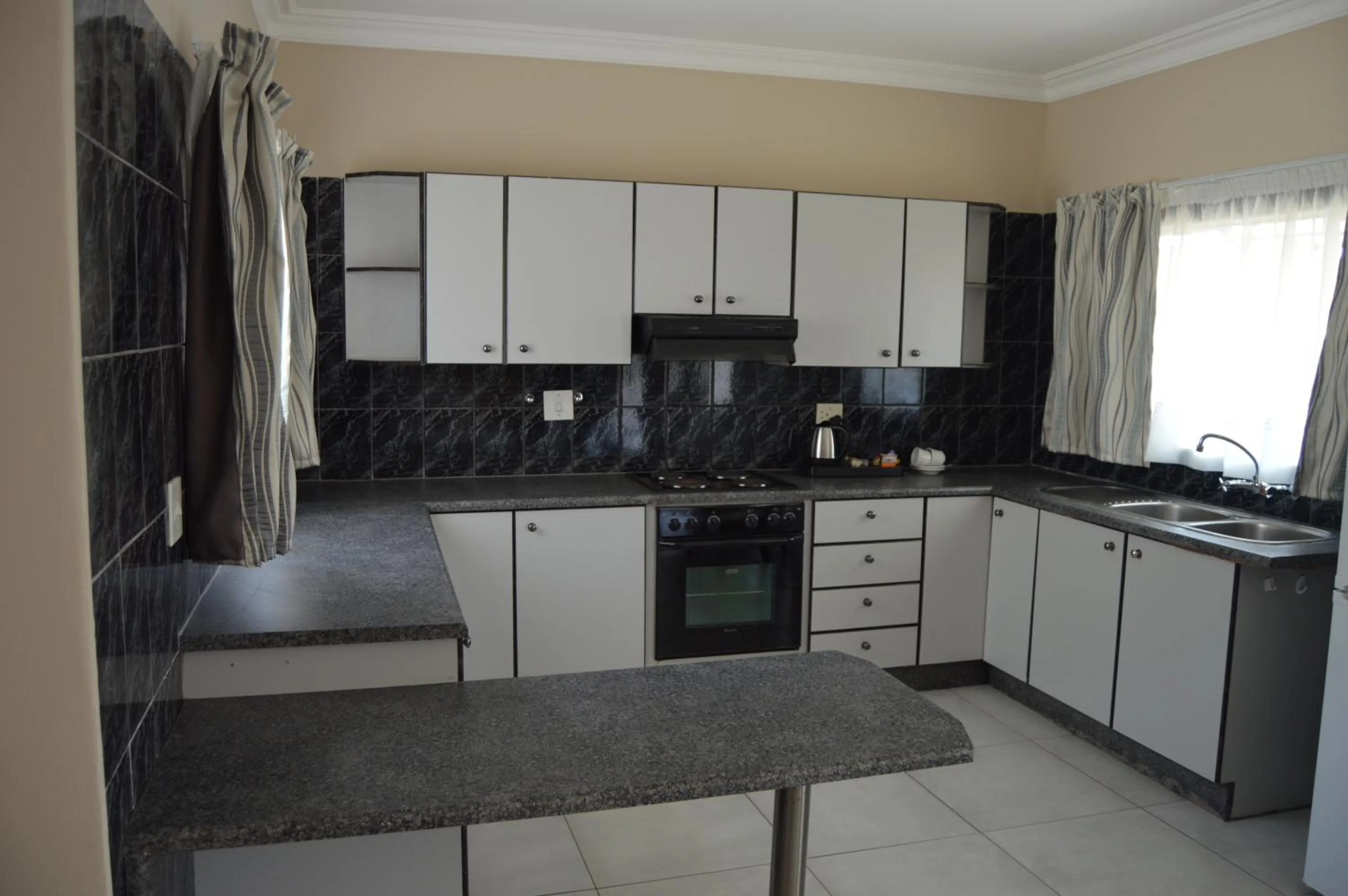 Kitchen or kitchenette in Airport Gardens Boutique Hotel