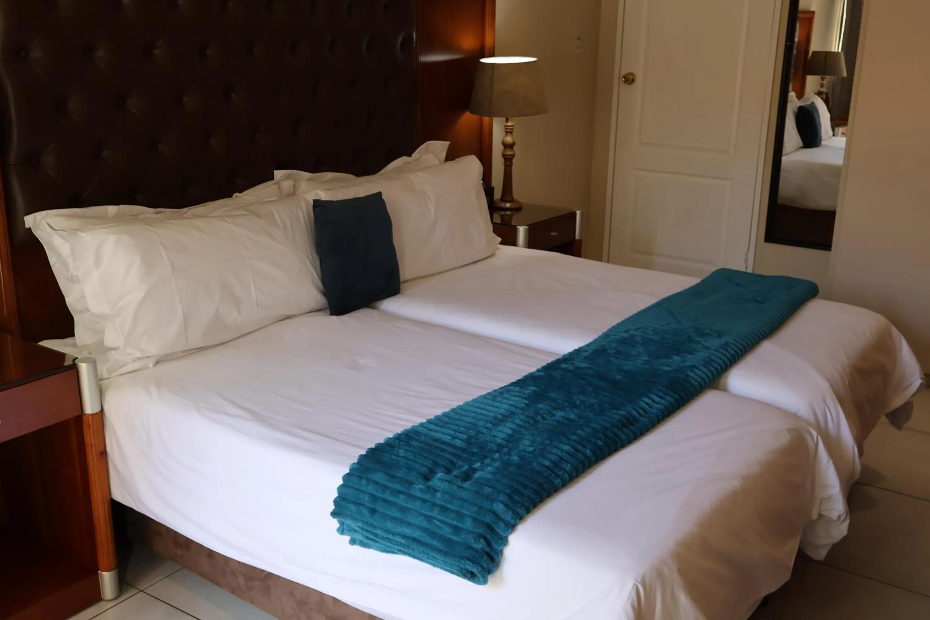 Bed in Airport Gardens Boutique Hotel