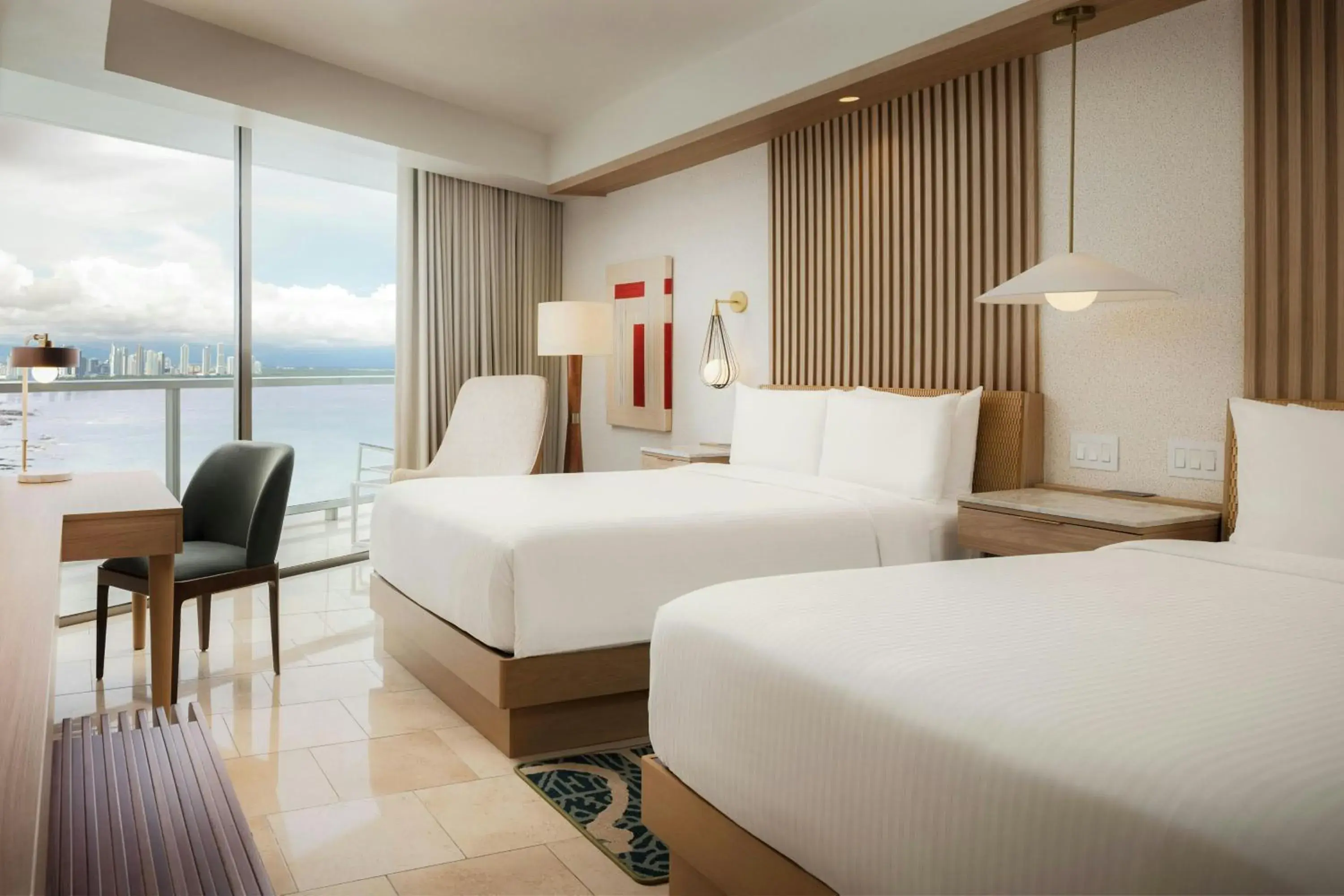Guest room with 2 double beds, balcony and partial ocean view in JW Marriott Panama Guest room with 2 double beds, balcony and partial ocean view in JW Marriott Panama