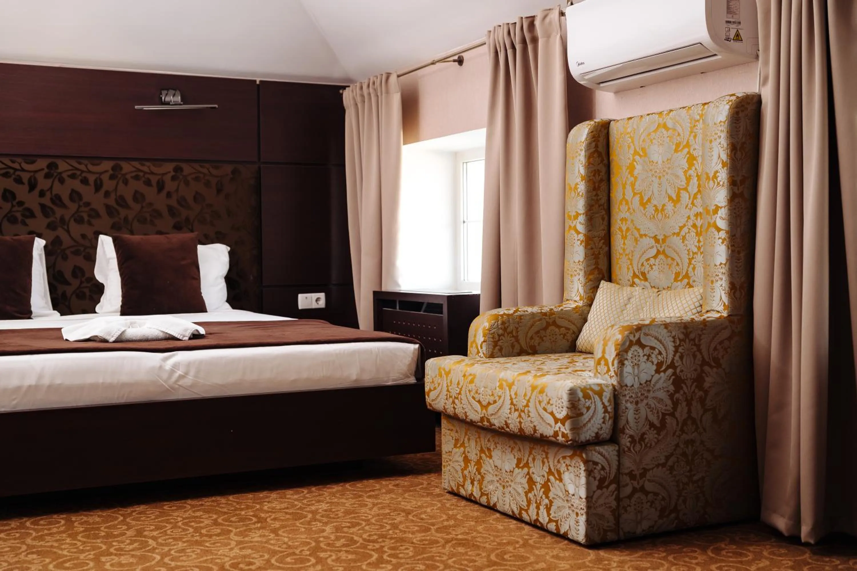 Bed in Maxim Pasha Hotel