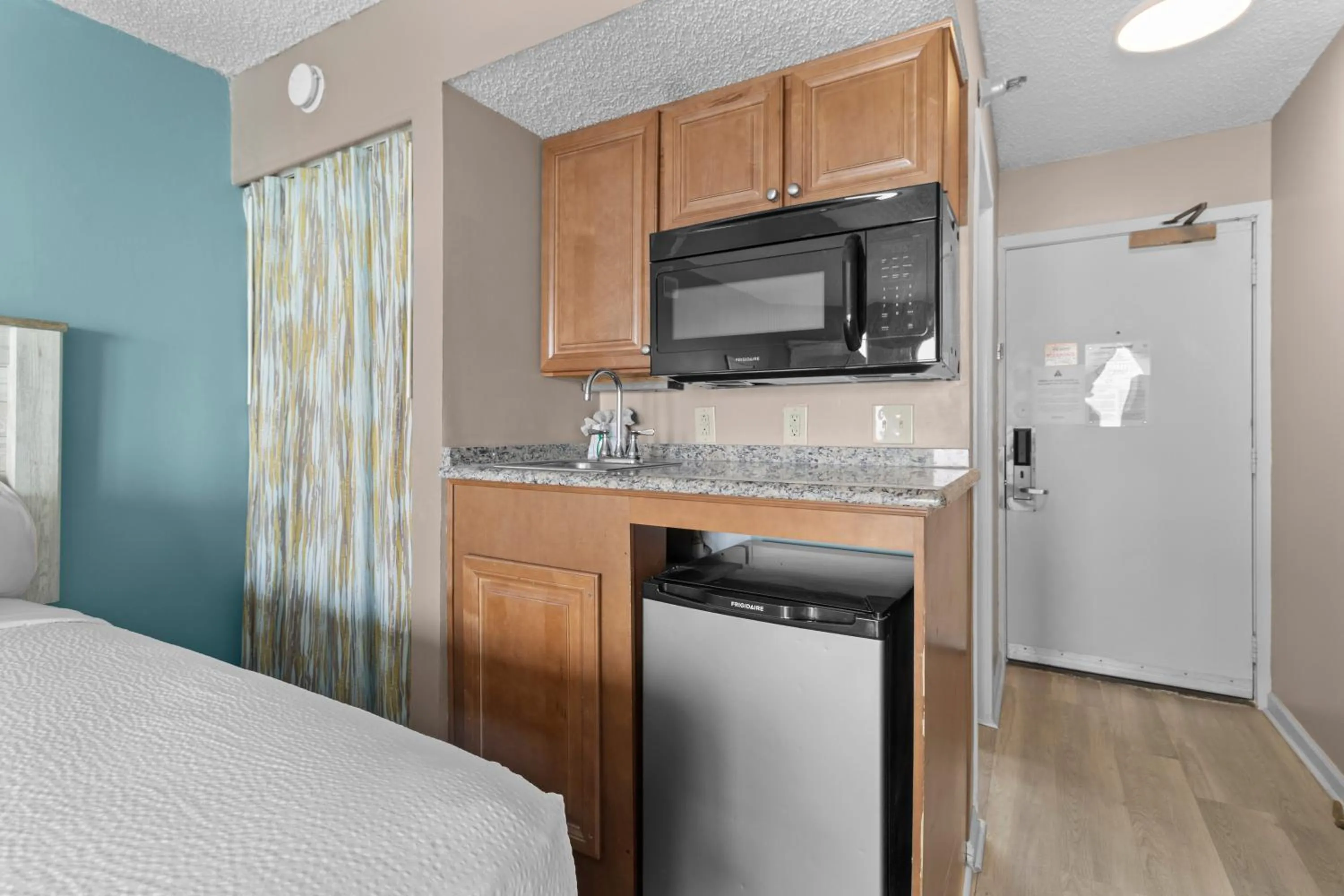 Kitchen or kitchenette, Bed in The Strand - A Boutique Resort