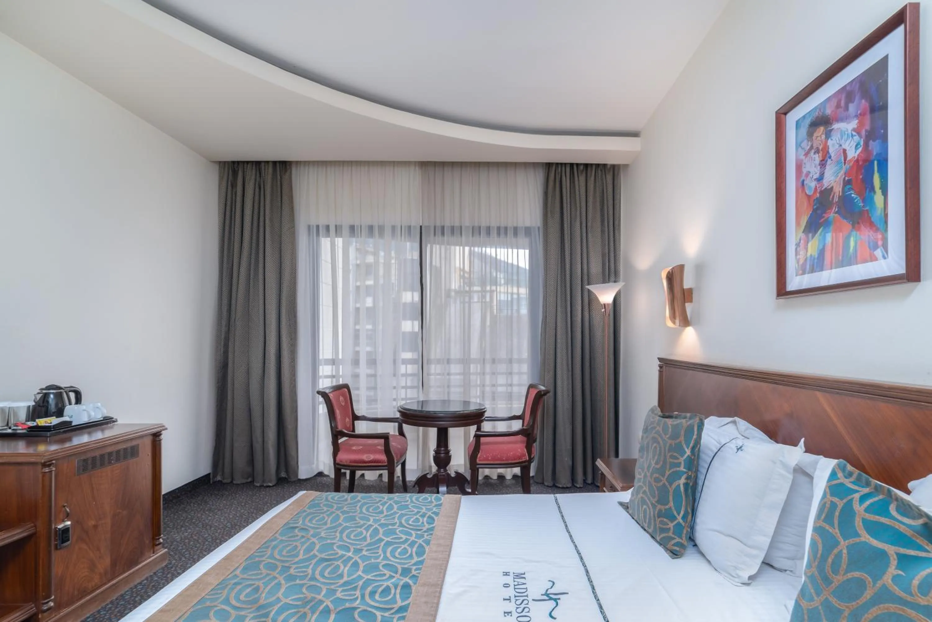 Seating area, Bed in Madisson Hotel