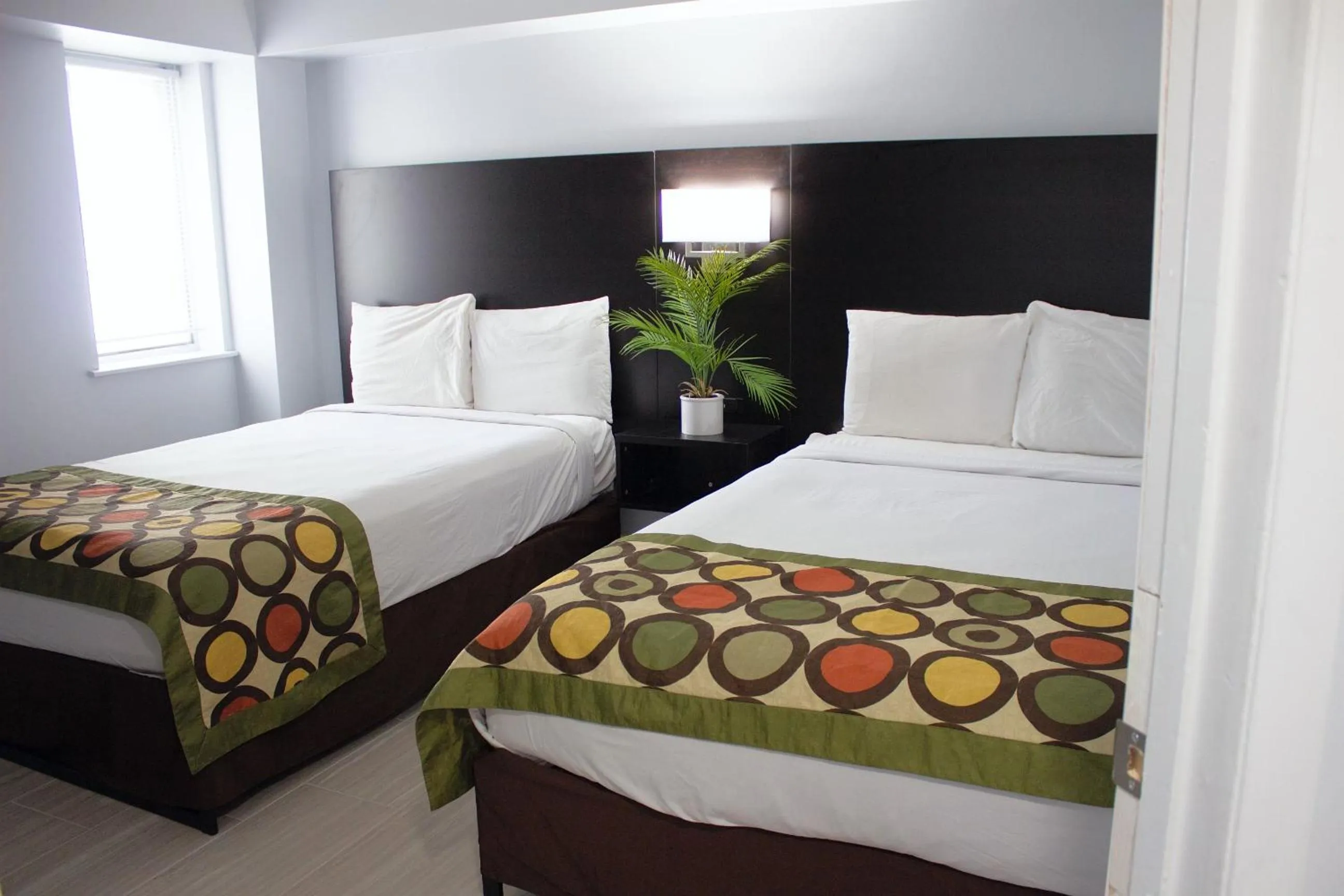 Bed in Sun & Sand Resort Oceanfront Suites