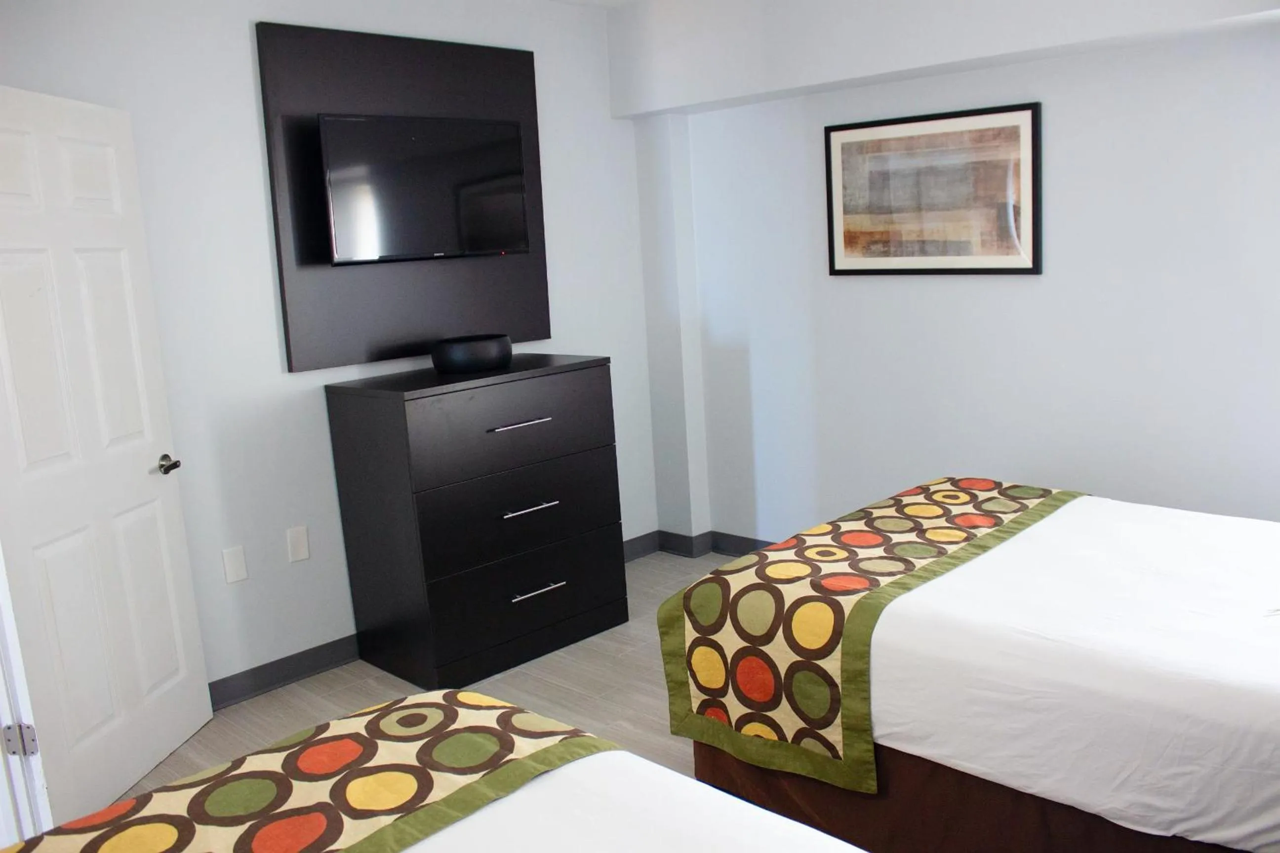 Bed in Sun & Sand Resort Oceanfront Suites