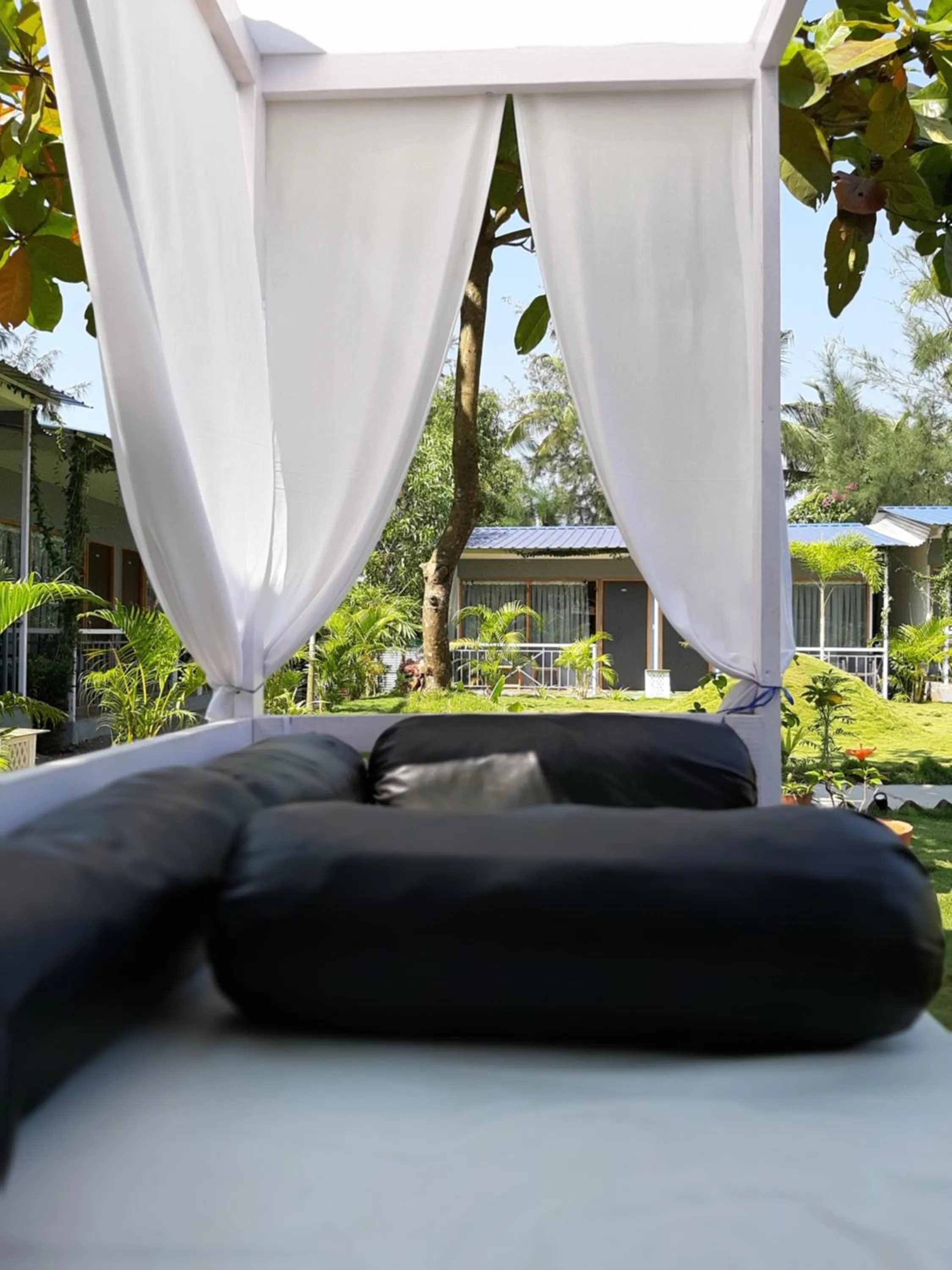 Seating area, Bed in Treebo Lands End Beach Resort Morjim