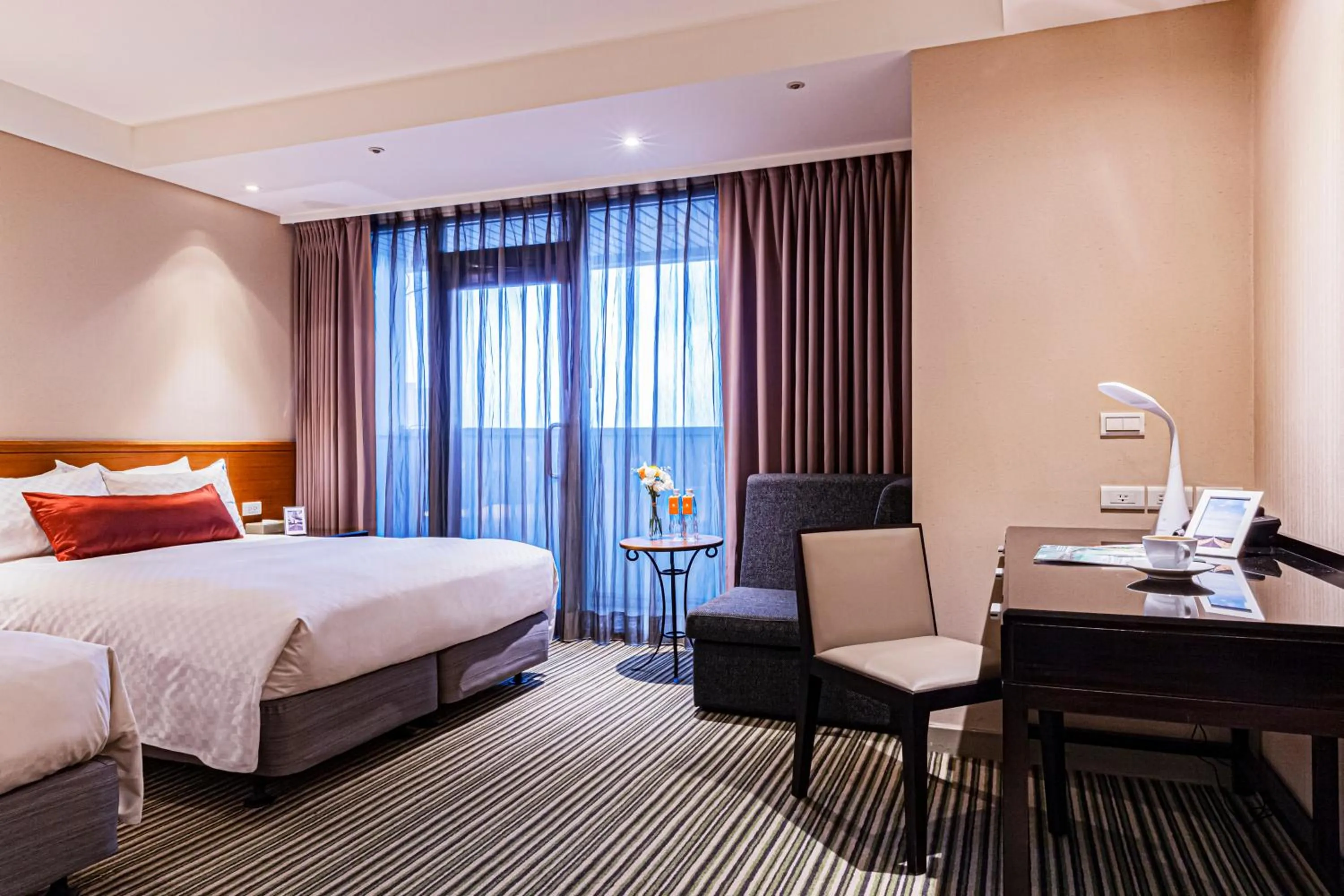 Bed in Pacific Business Hotel