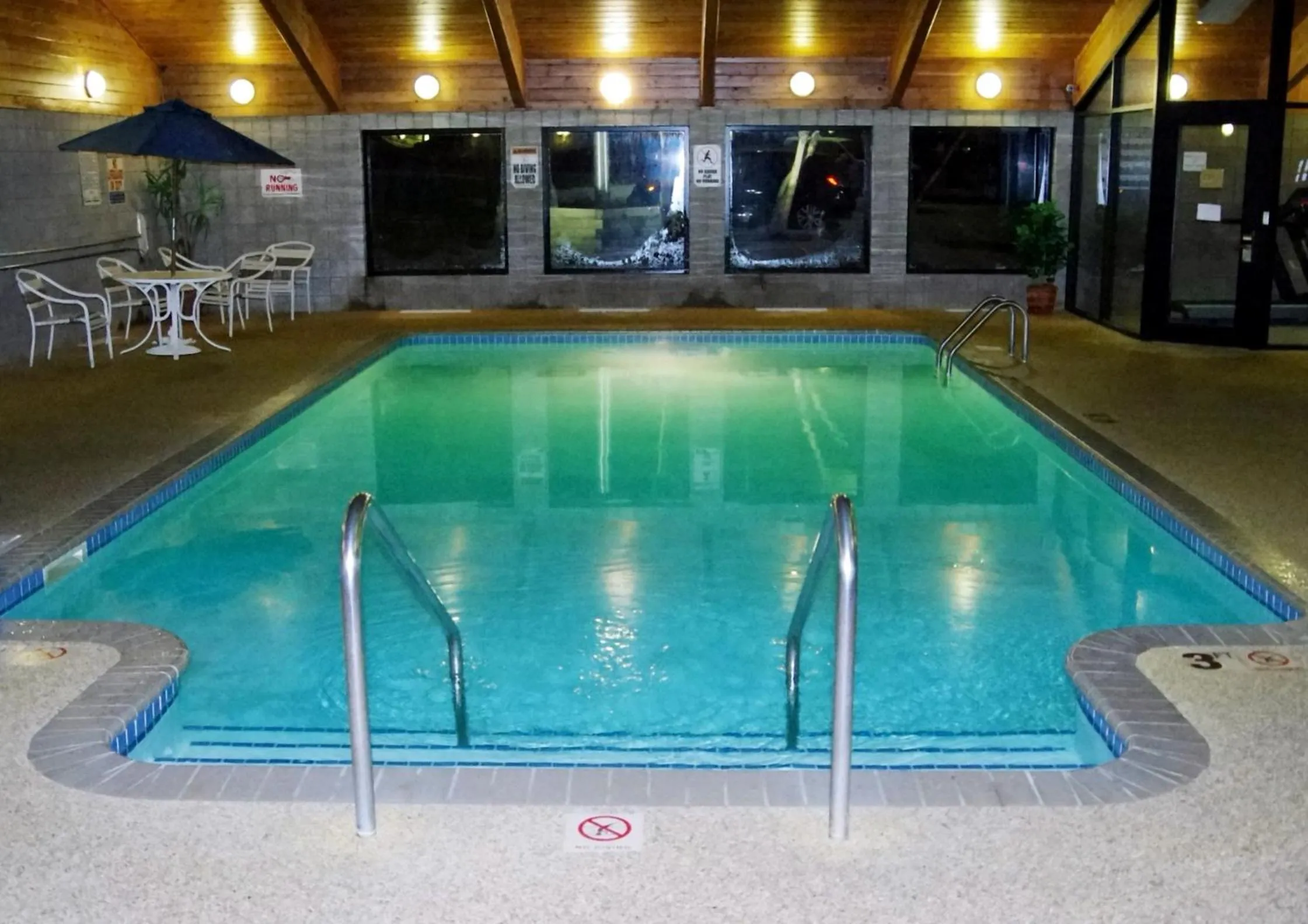 Swimming pool in AmericInn by Wyndham Grimes