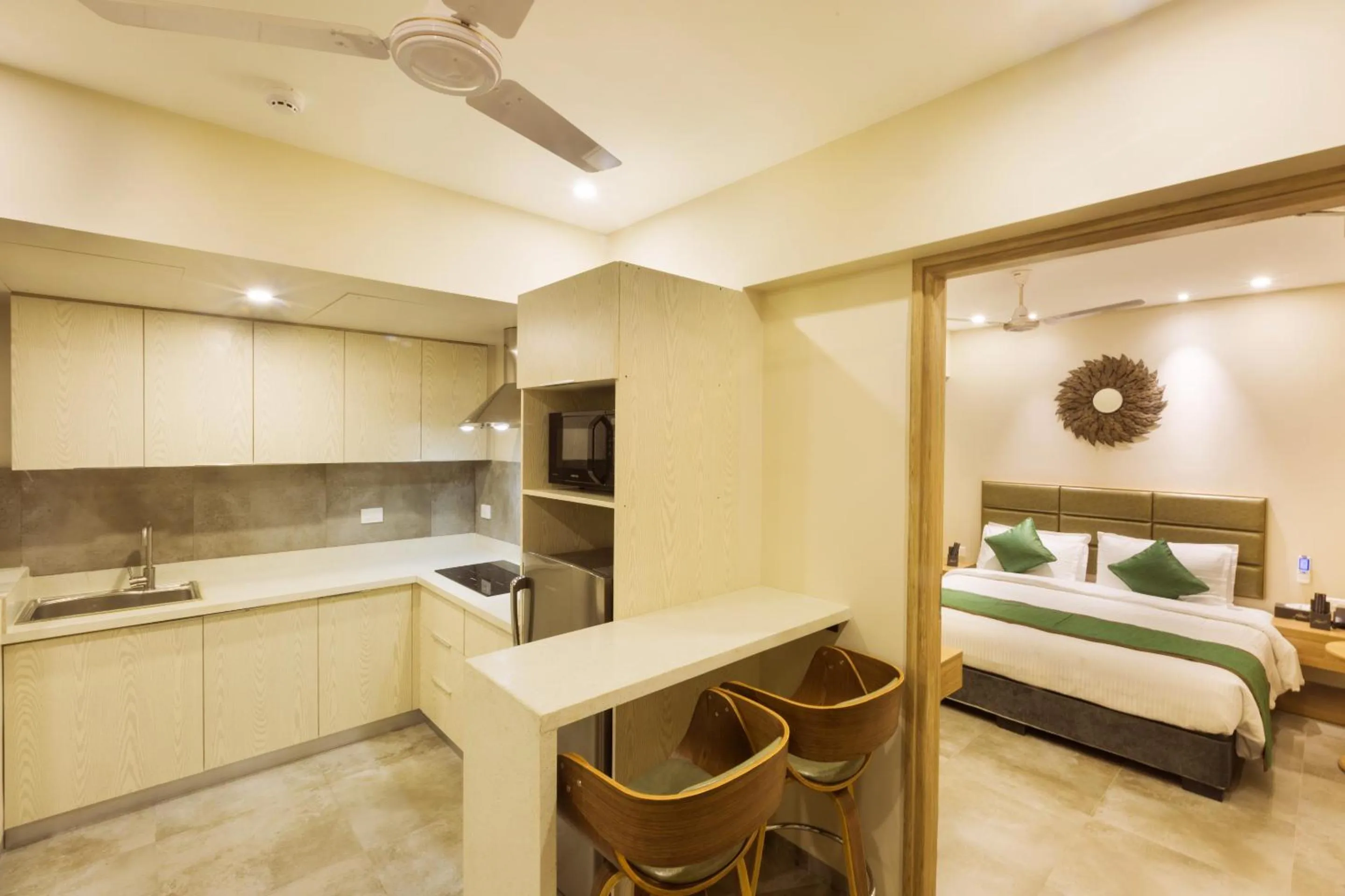 Kitchen or kitchenette, Bed in Floressa Randa Business Hotel