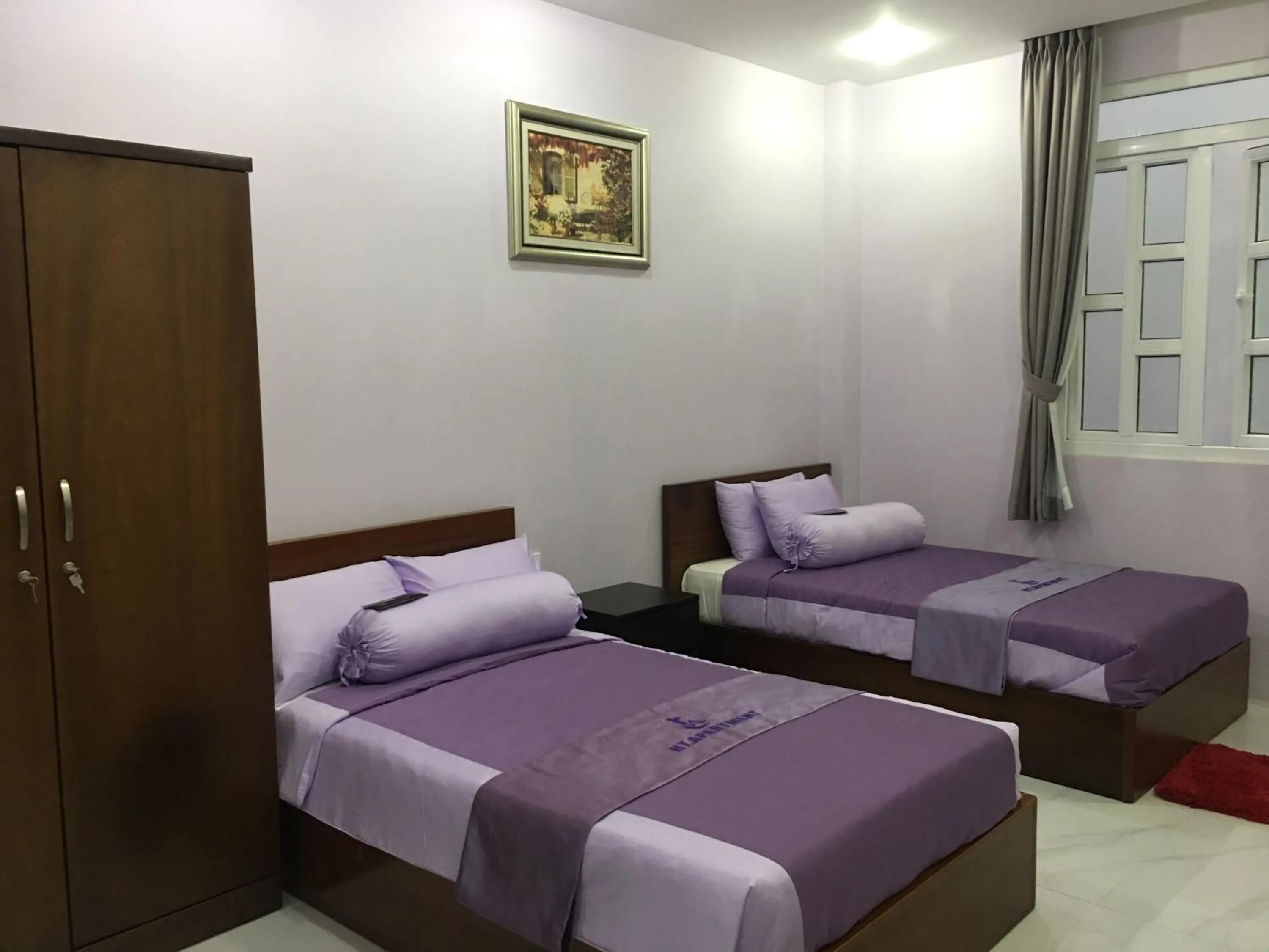 Bed in HT Hotel Apartment