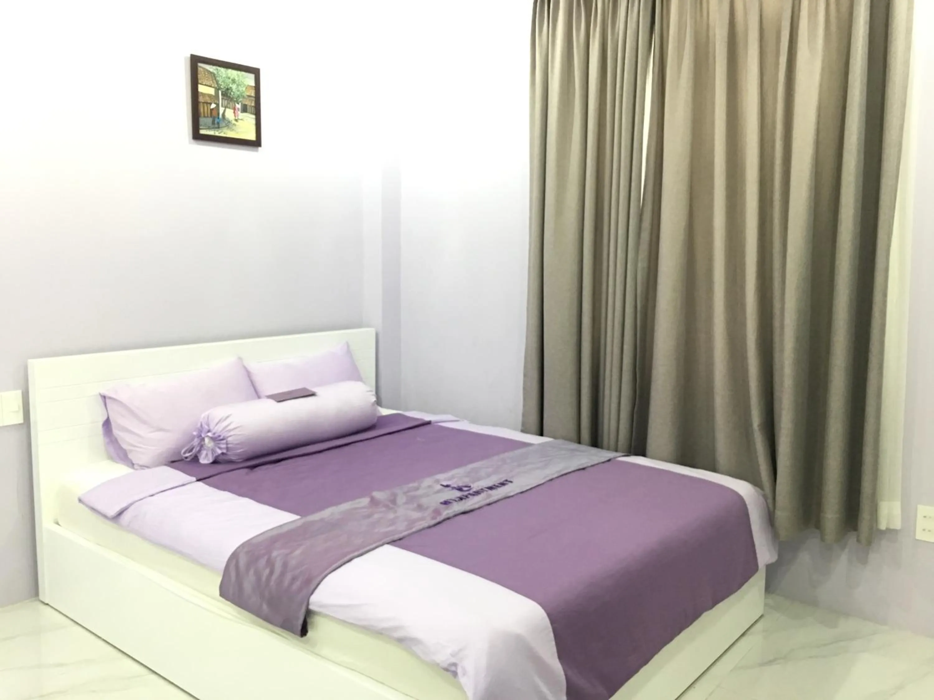 Bed in HT Hotel Apartment