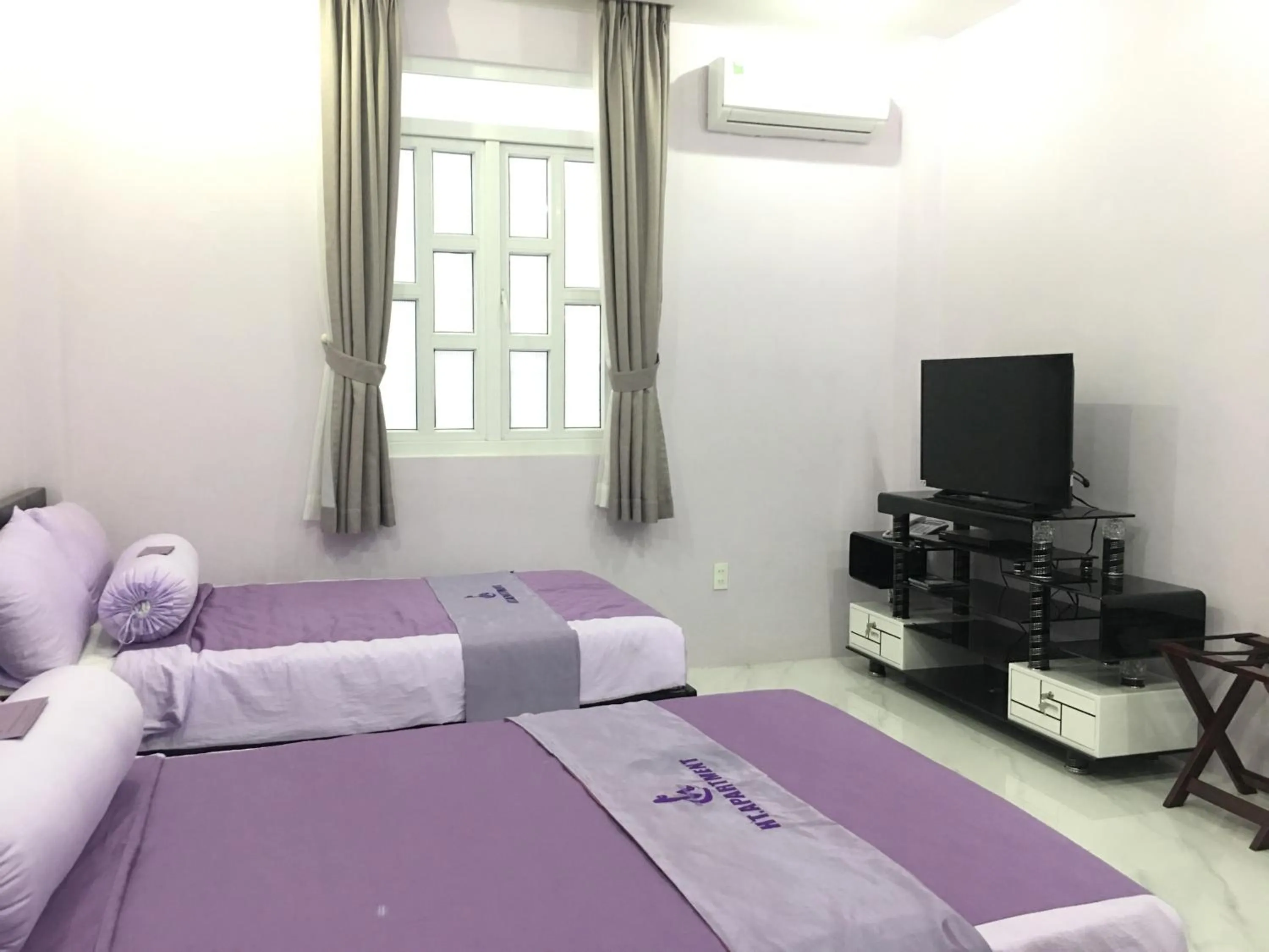 Bed in HT Hotel Apartment