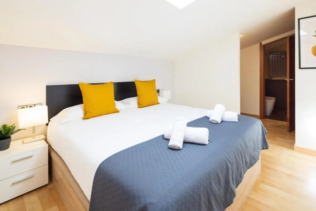 Bed in Lucas House Apartments by Sitges Group
