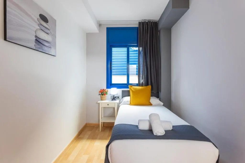 Bed in Lucas House Apartments by Sitges Group