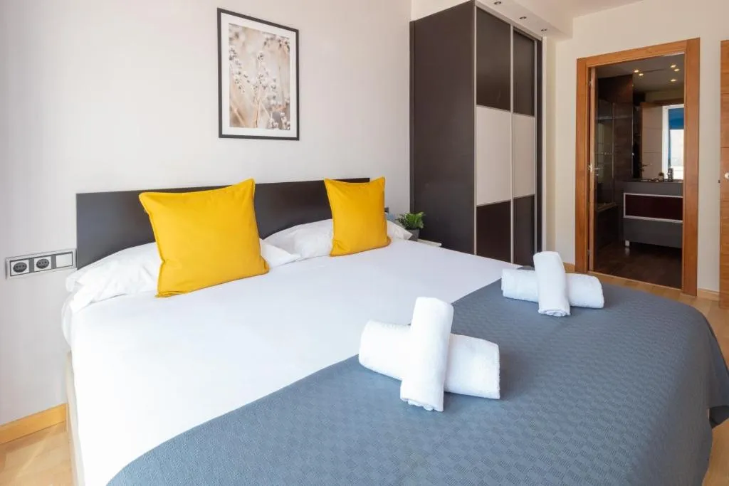 Bed in Lucas House Apartments by Sitges Group