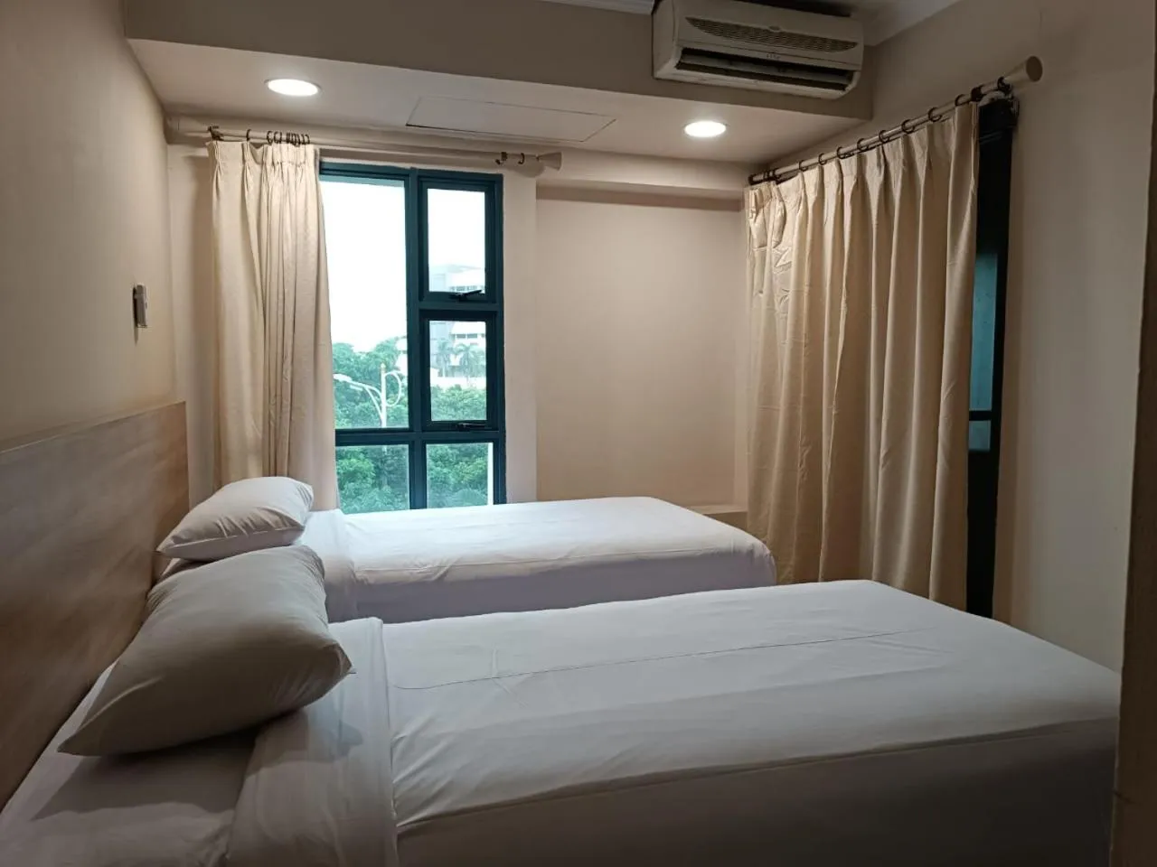 Bed in Grand Tropic Suites Hotel