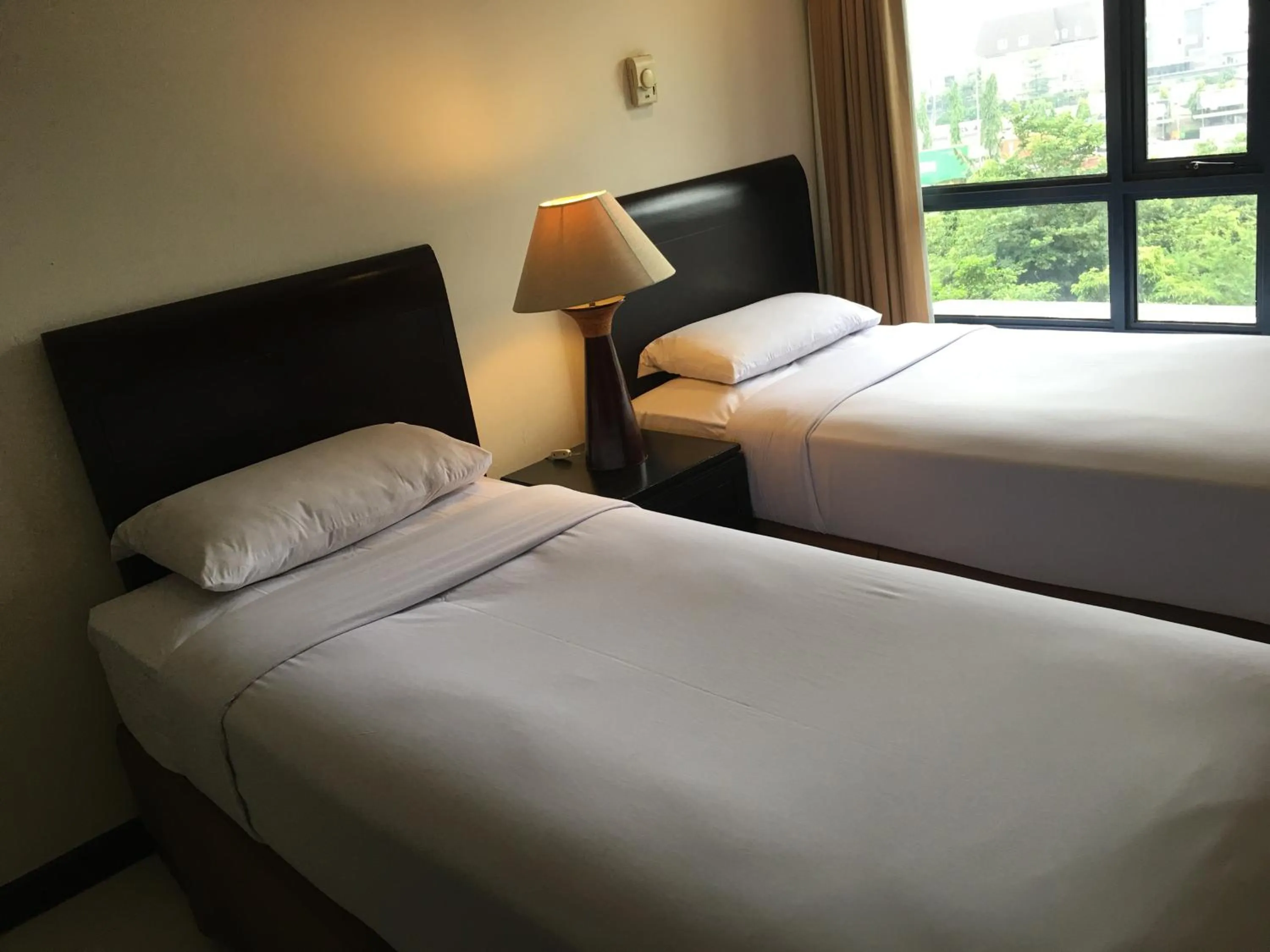 Bed in Grand Tropic Suites Hotel
