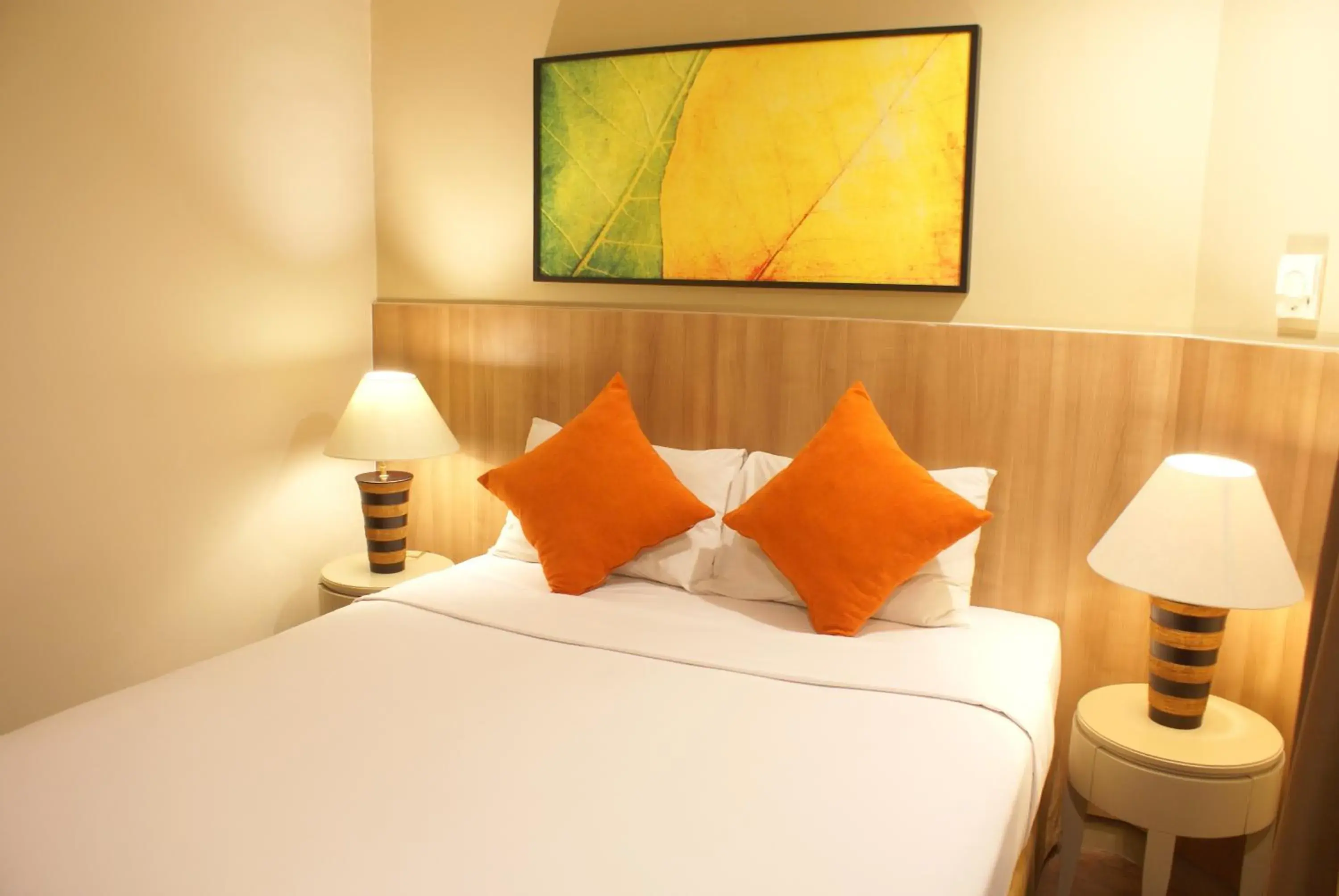 Bed in Grand Tropic Suites Hotel