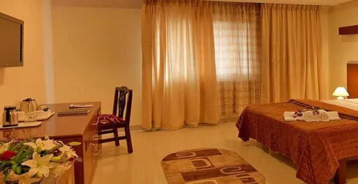 Photo of the whole room, Bed in Dhanunjayas Luxury Hotel