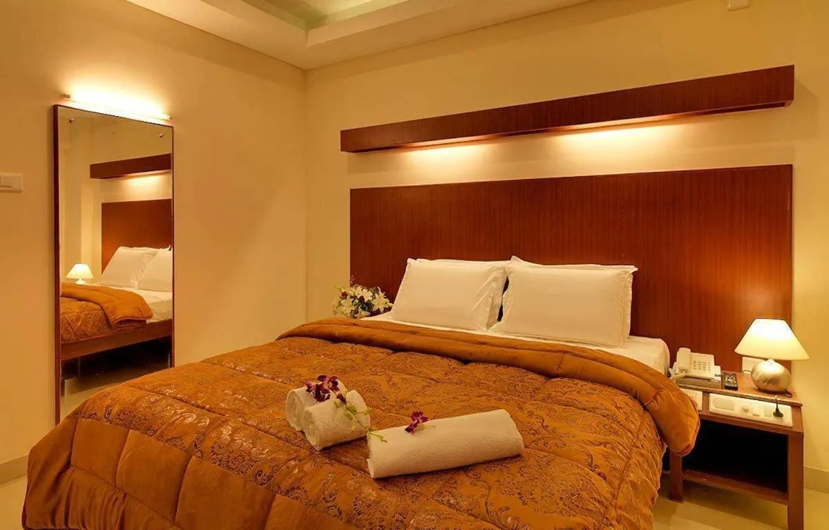 Photo of the whole room, Bed in Dhanunjayas Luxury Hotel