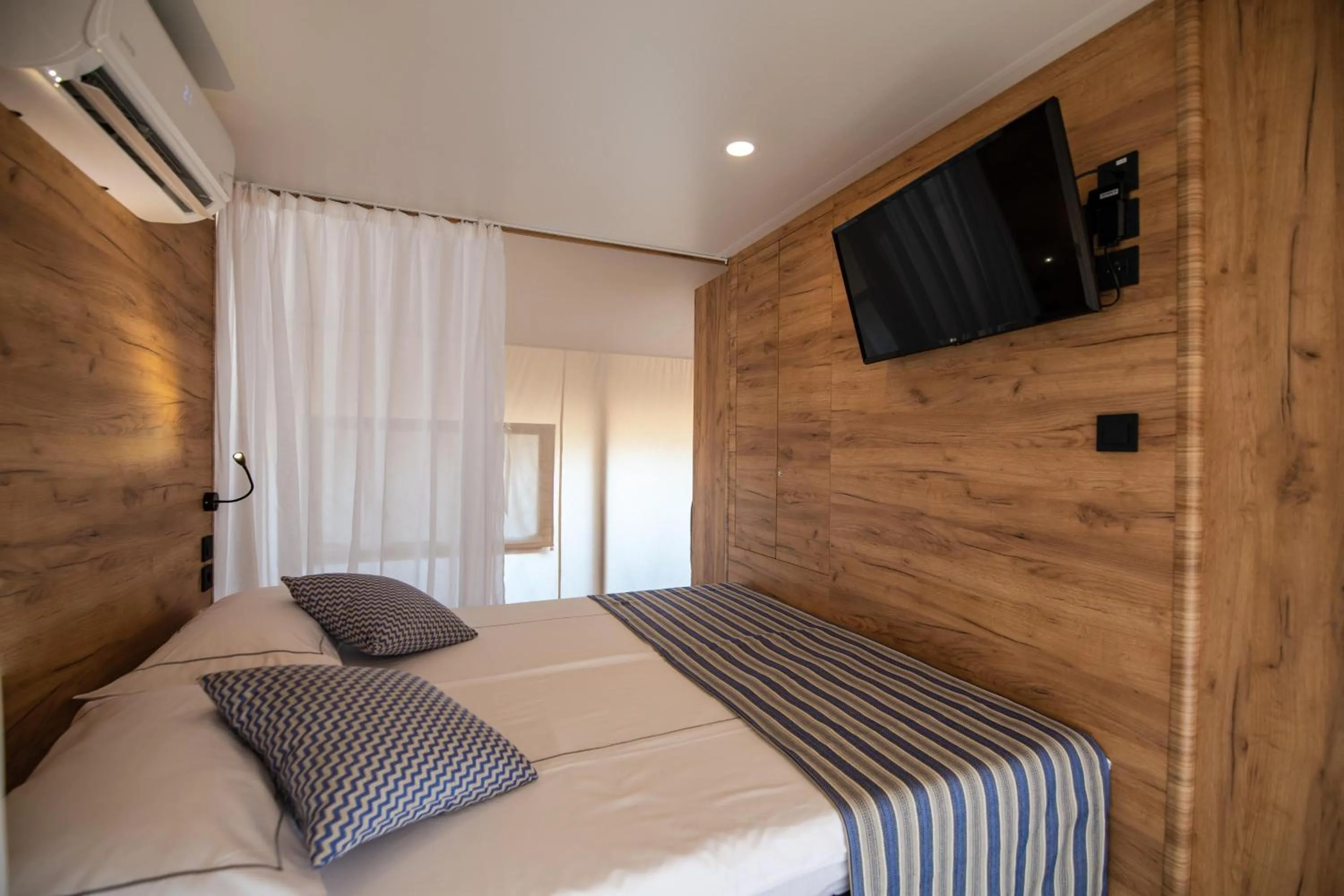 Bed in Arena One 99 Glamping